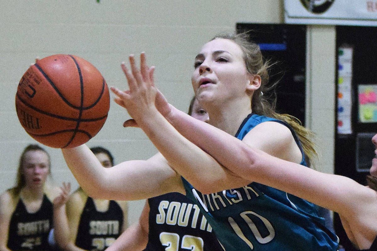 Nikiski’s Lillian Carstens drives to the rim by South’s Paige Noble Saturday at the Rus Hitchcock Nikiski Tip Off tournament. (Photo by Joey Klecka/Peninsula Clarion)