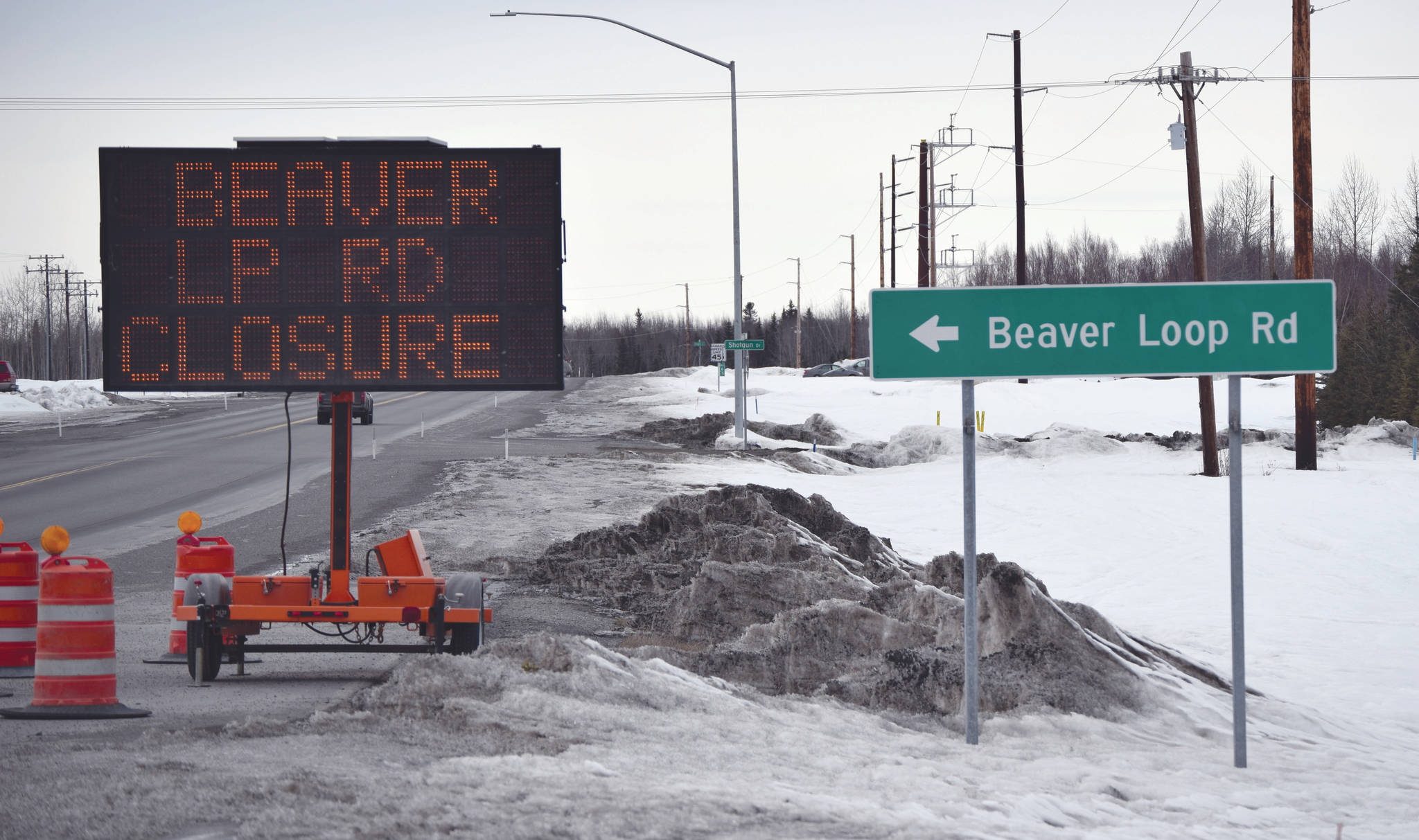A sign at the intersection of Beaver Loop Road and Kenai Spur Highway tells motorists of impending construction Tuesday, April 7, 2020, in Kenai, Alaska. (Photo by Jeff Helminiak/Peninsula Clarion)