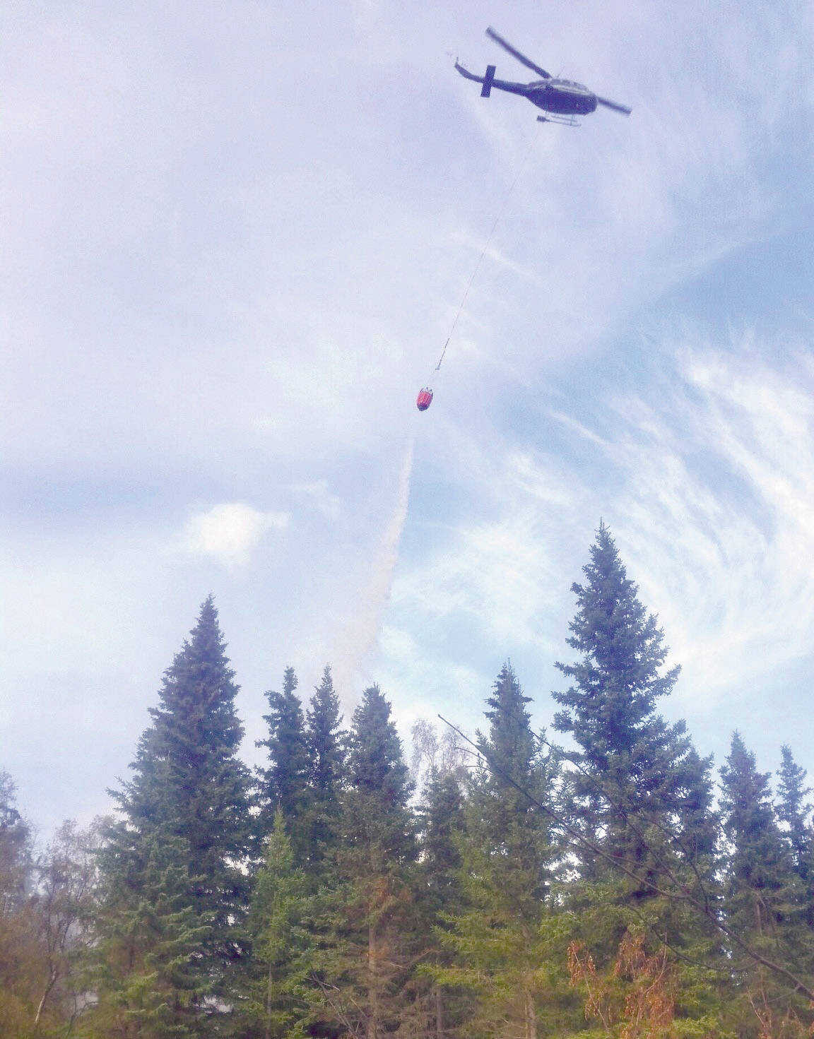 A helicopter performing heli-bucket drops on the Swan Lake Fire in 2019. (Photo by Mike McNulty/Kenai National Wildlife Refuge)