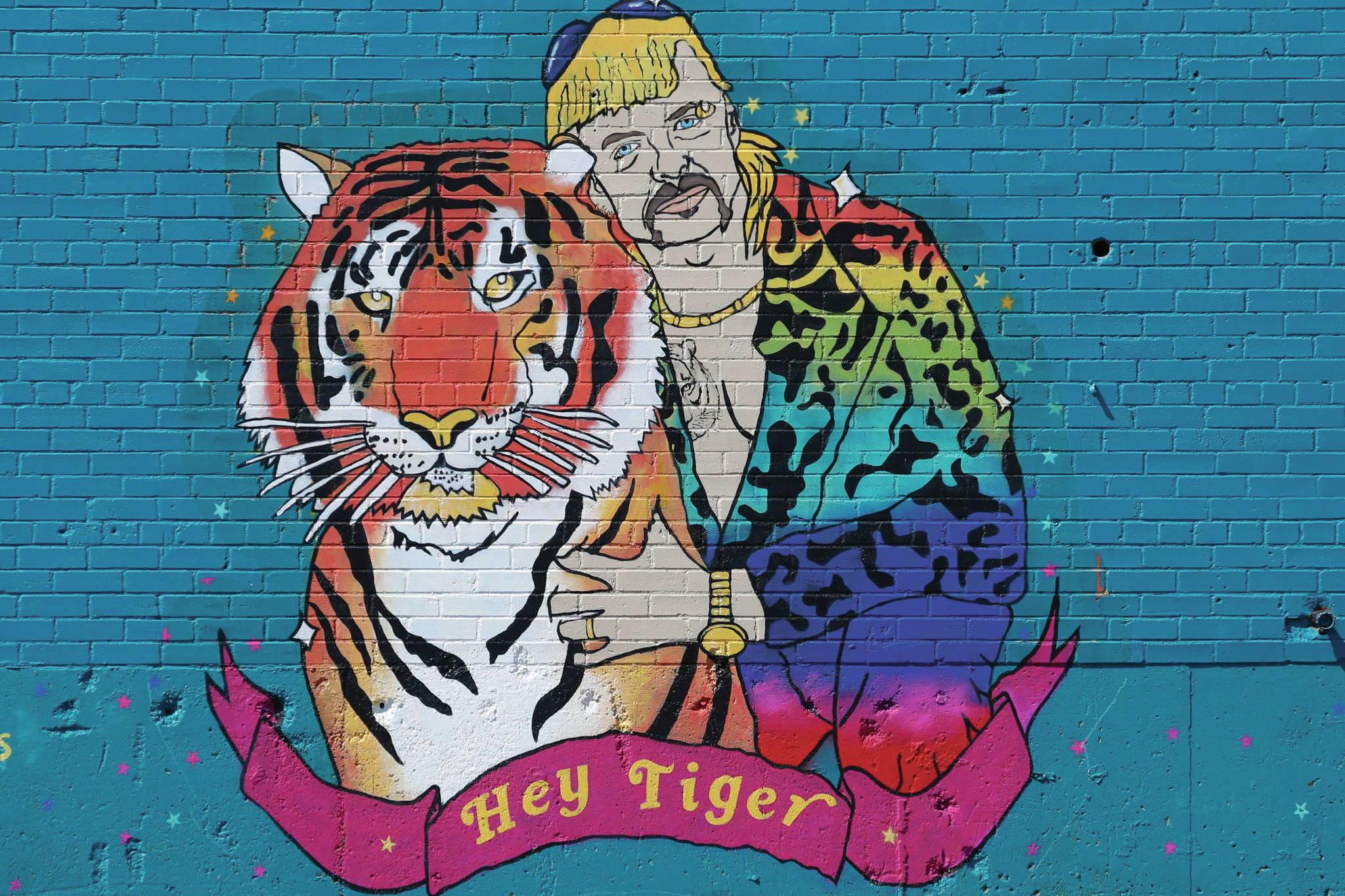 A mural depicting Joseph Maldonado-Passage, also known as as “Joe Exotic,” in Dallas, Friday, April 10, 2020. The Netflix series “Tiger King,” has become popular watching during the COVID-19 outbreak. Maldonado-Passage was convicted in an unsuccessful murder-for-hire plot. (AP Photo/LM Otero)