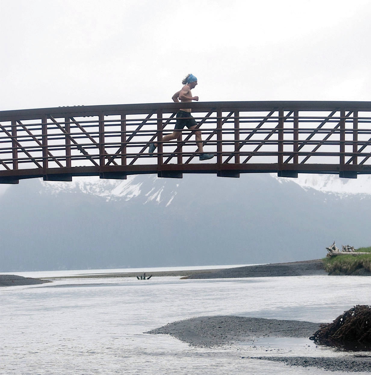 Jeff Helminiak / Peninsula Clarion                                 Pyper Dixon crosses a bridge during the Dixon/Holden Memorial Tonsina Beach Trail Run on May 31 in the Caines Head State Recreation Area in Seward.