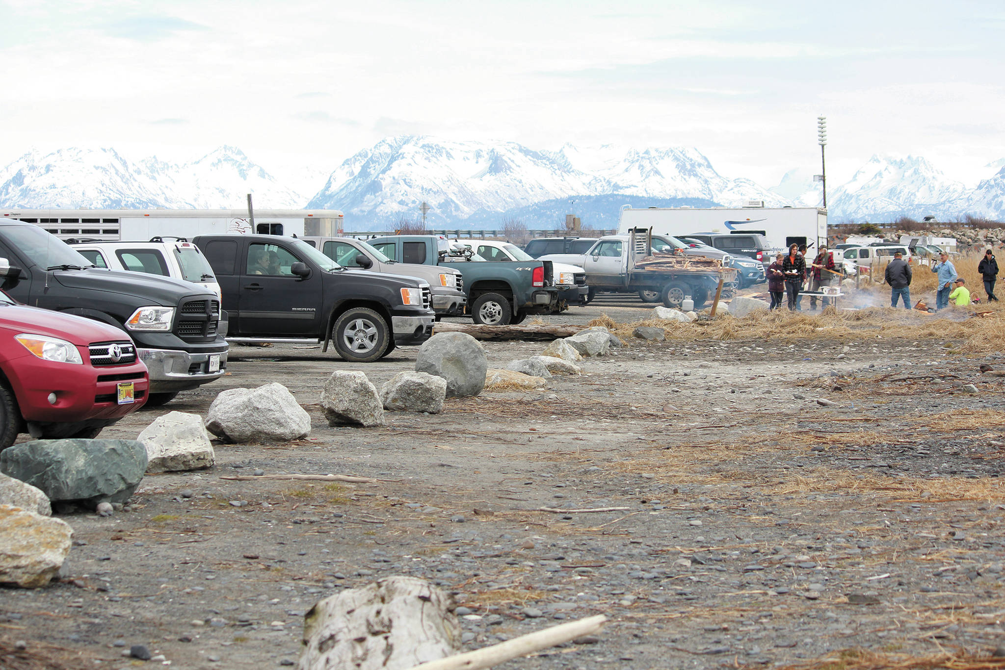 Cars line the parking lot at Mariner Park while participants in a community gathering and barbecue event spend time together on the beach Saturday, April 18, 2020 at the park in Homer, Alaska. The gathering was held by the Homer’s Sons of Liberty while the state health mandate that bans all in-person gatherings was still in place. (Photo by Megan Pacer/Homer News)