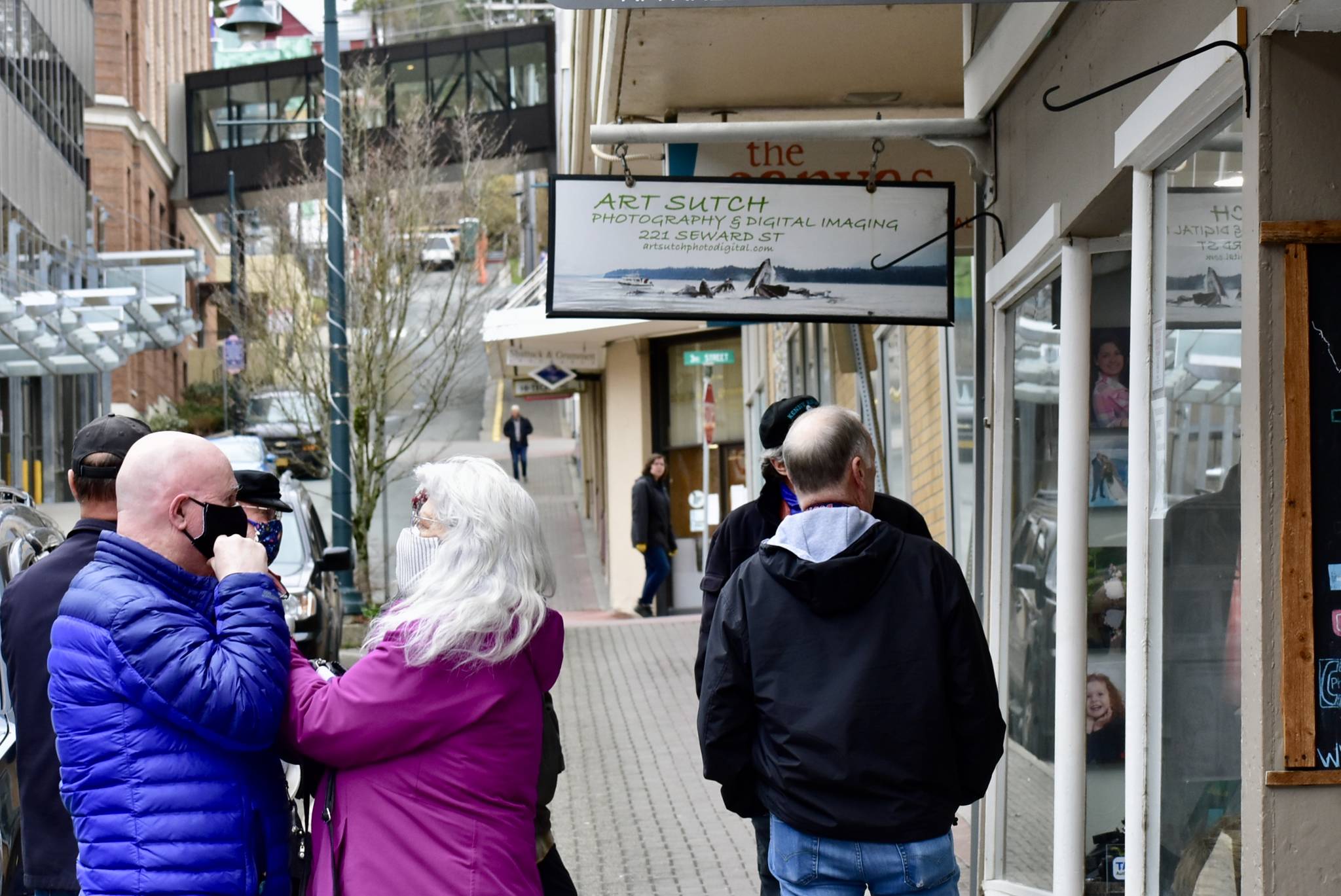 Peter Segall | Juneau Empire                                 Patrons wait outside a shop in downtown Juneau on Friday.