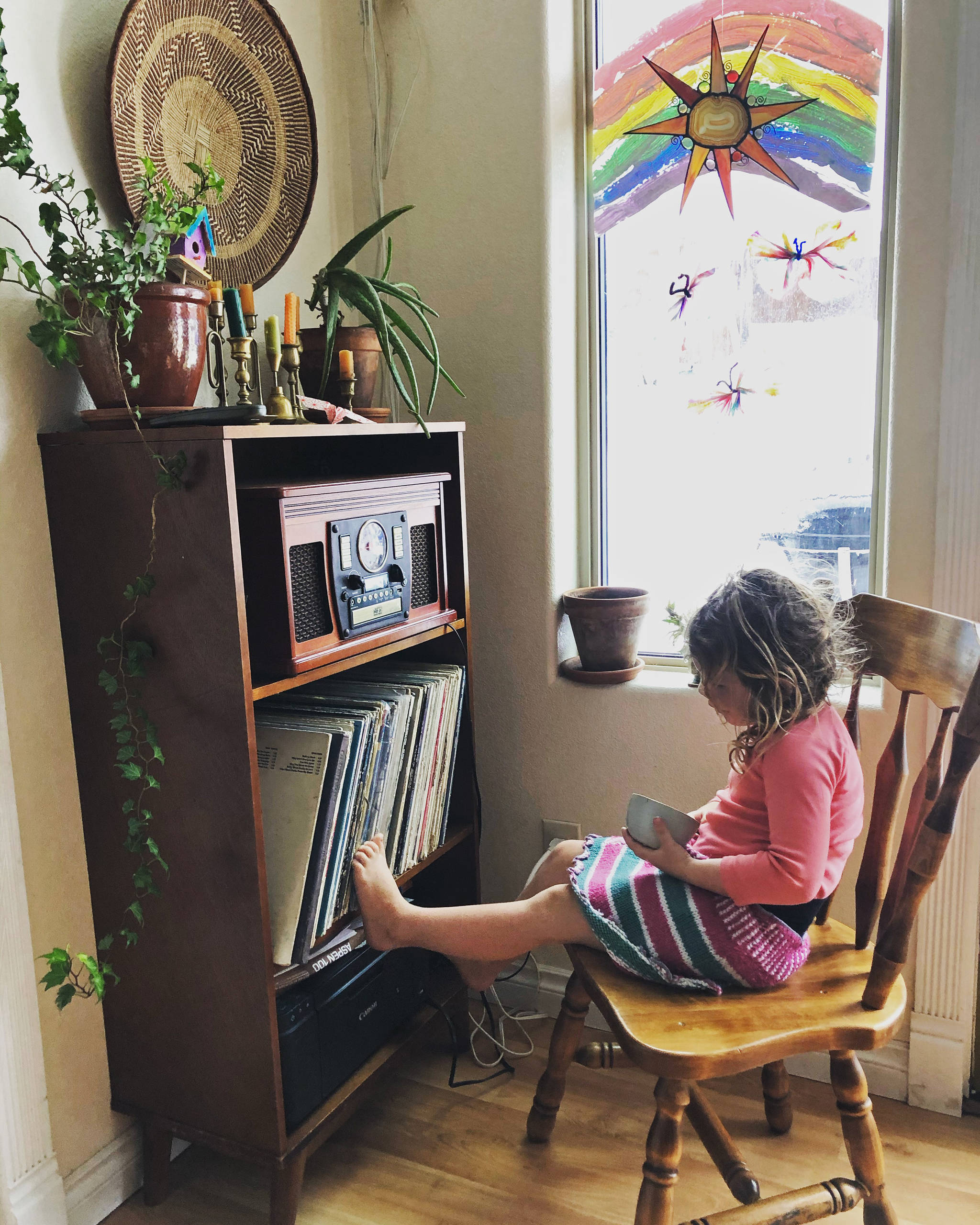 In this April 2, 2020, photo provided by Cassy Quinlan, 4-year-old Polly Fraley listens in Homer, Alaska, to childrens stories being read on air at local radio station KBBI by librarian Claudia Haines. The library teamed up with the station to continue its popular story hour for preschoolers after it closed to the public amid coronavirus concerns. Its among ways the nations libraries are dealing with closures amid coronavirus concerns. (Cassy Quinlan via AP)