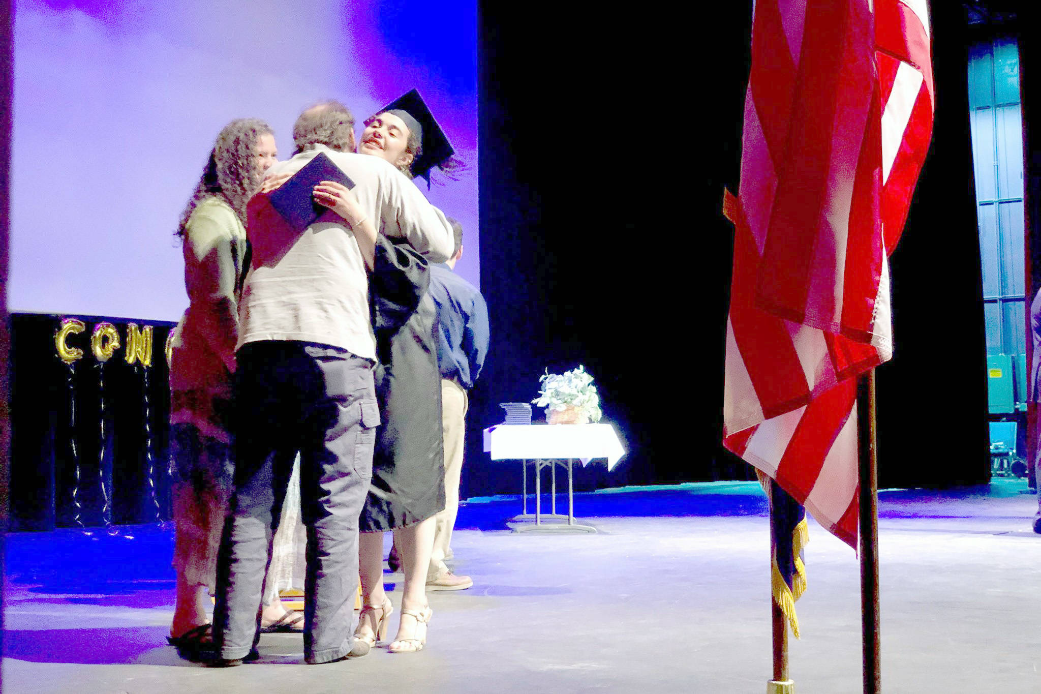 Victoria Petersen / Peninsula Clarion file                                 Emerald Miller receives her high school diploma from her parents at the Kenai Peninsula Borough School District Connections home-school program graduation ceremony May 23, 2019, in Soldotna.