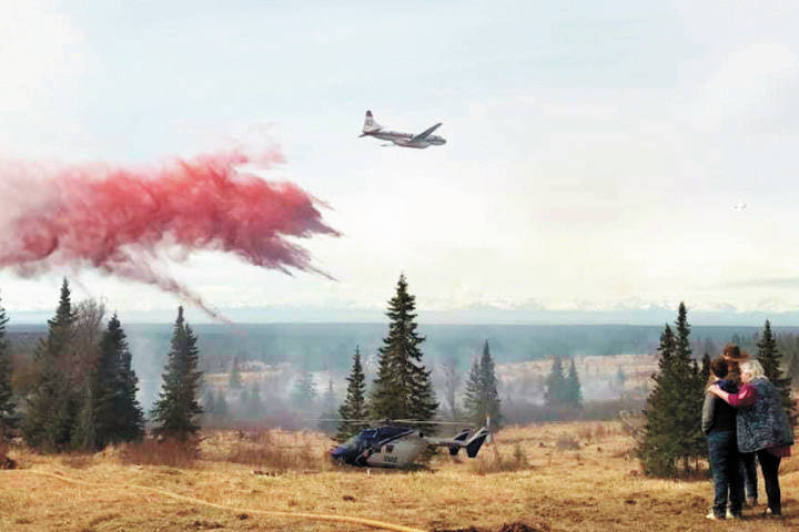 Fire retardant is dropped from a Convair 580 air tanker contracted by the State Division of Forestry from Conair Group, Inc. of Abbottsford, British Columbia, onto a wildland fire Sunday, May 10, 2020 near Ninilchik, Alaska. This was the first retardant drop of the fire season for the Division of Forestry. (Photo courtesy Alaska Division of Forestry)