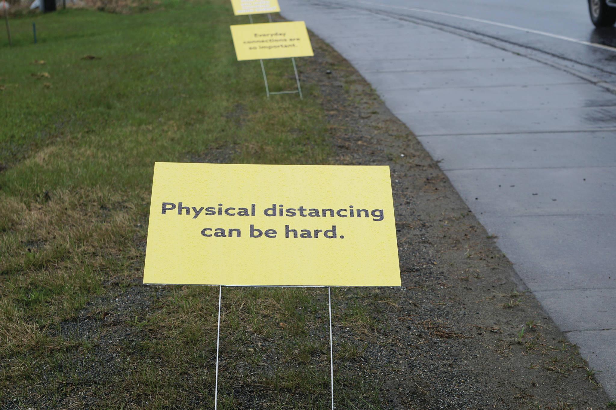 Signs on May 7, 2020, along the Sterling Highway by St. Augustine’s Episcopal Church in Homer, Alaska, and put up by the South Kenai Peninsula Resiliency Coalition offer encouragement during the COVID-19 pandemic. The signs read “Physical distancing can be hard. Everyday connections are so important. How can you make someone smile today?” (Photo by Michael Armstrong/Homer News)