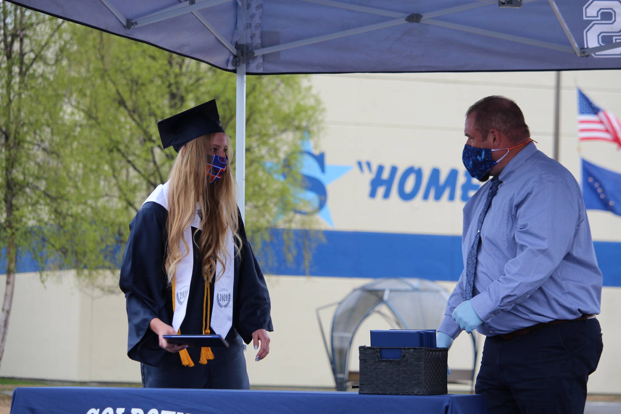 Cameron Blackwell, a graduate and valedictorian of the class of 2020 at Soldotna High School, receives her diploma from principal Tony Graham Soldotna High School in Soldotna, Alaska on May 18, 2020. (Photo by Brian Mazurek/Peninsula Clarion)
