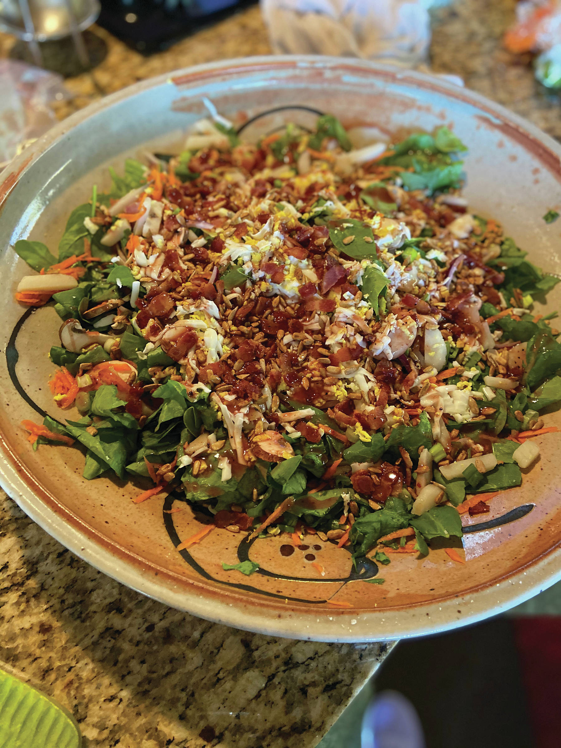 Teri’s Special Spinach Salad with Hot Bacon and Red Wine Vinaigrette features a tasty bacon dressing over spinach, eggs, chopped chestnuts and other ingredients. She made her recipe on May 17, 2020, at her kitchen in Homer, Alaska. (Photo by Teri Robl)