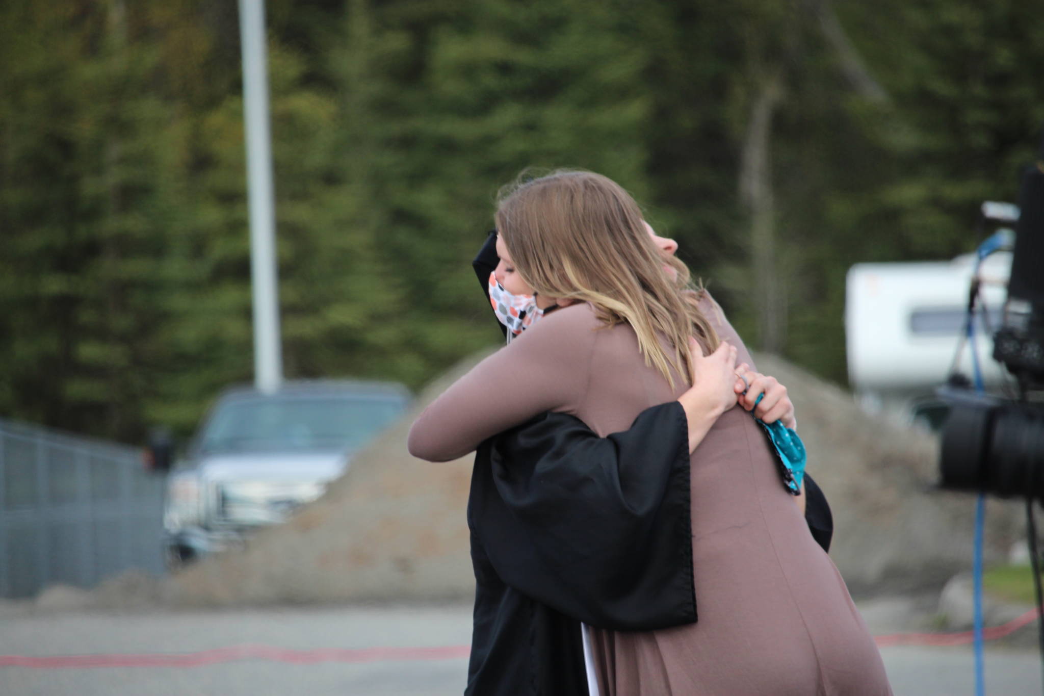 Class valedictorian America Jeffreys hugs her mom after giving a speech during the 2020 Nikiski High School Graduation Commencement Ceremony in Nikiski, Alaska on May 19, 2020. (Photo by Brian Mazurek/Peninsula Clarion)