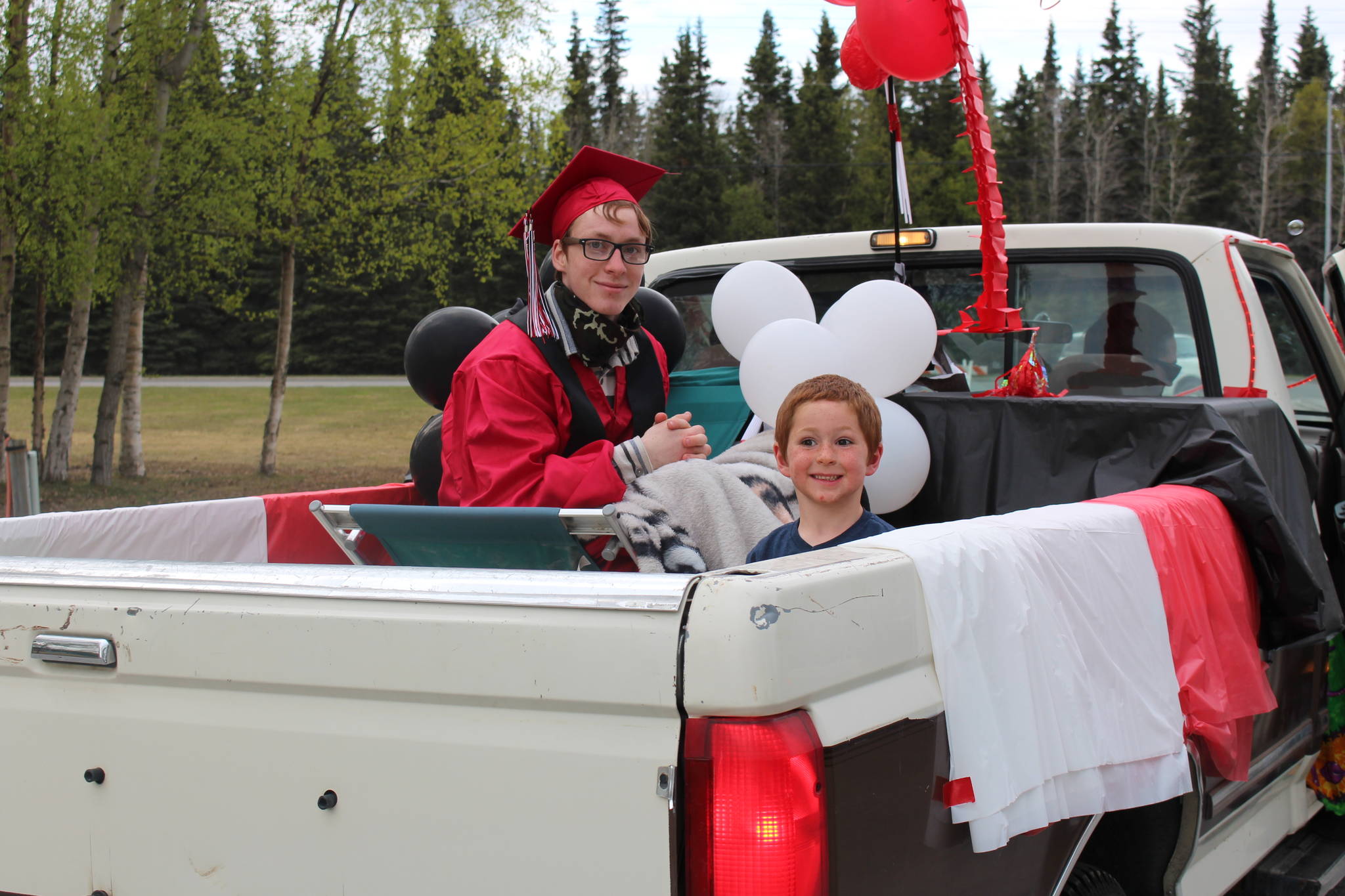 Senior Devin Murphy and his little brother Brody participate in Kenai Central High School’s Class of 2020 Graduation Parade in Kenai, Alaska, on May 20, 2020. (Photo by Brian Mazurek/Peninsula Clarion)