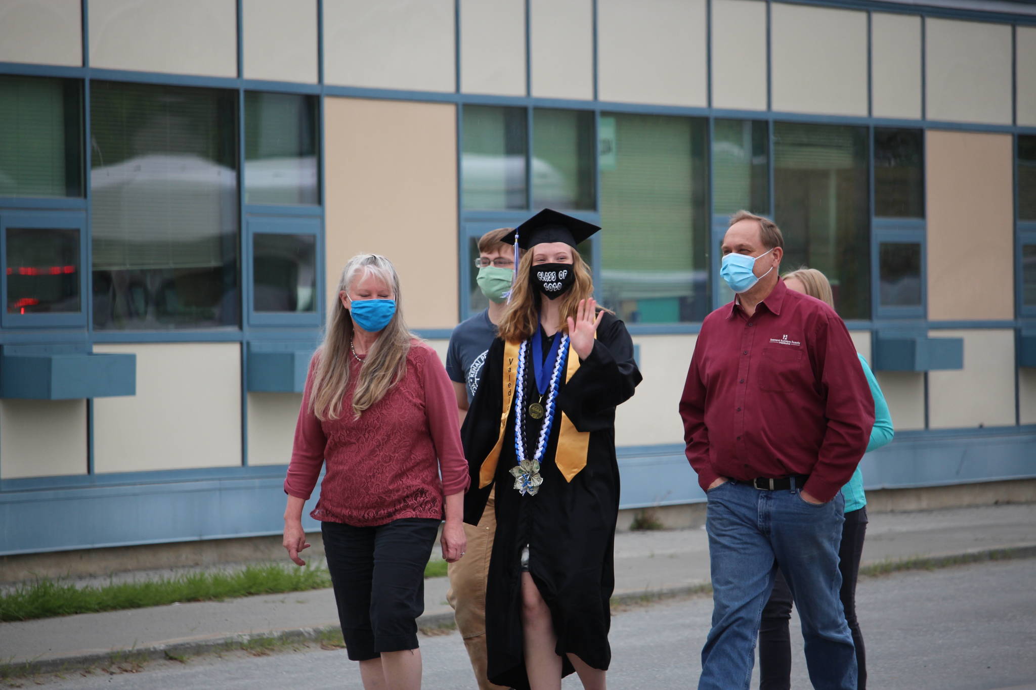 Photos by Brian Mazurek/Peninsula Clarion                                Graduate and valedictorian Katherine Stoll walks with her family to receive her diploma during the Connections Homeschool Class of 2020 graduation at Soldotna Elementary School in Soldotn on May 21.