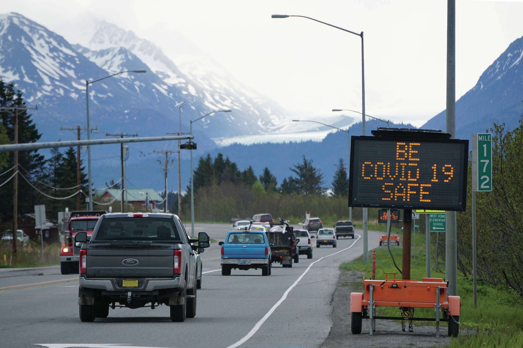 Road signs near Mile 172 Sterling Highway on Friday, May 22, 2020, in Homer, Alaska, greet visitors with messages about how to find information on the COVID-19 pandemic. Trafic was heavy on Friday morning at the start of the Memorial Day weekend and the first day of the phases three and reopening in Alaska. (Photo by Michael Armstrong/Homer News)