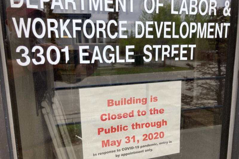 A sign on the door of the state labor department office in Anchorage, Alaska, on Friday, May 22, 2020, shows the office is closed to the public through the end of May. A report released by the department Friday showed the number of jobs in Alaska in April was down sharply compared to April 2019 amid coronavirus concerns. (AP Photo/Mark Thiessen)