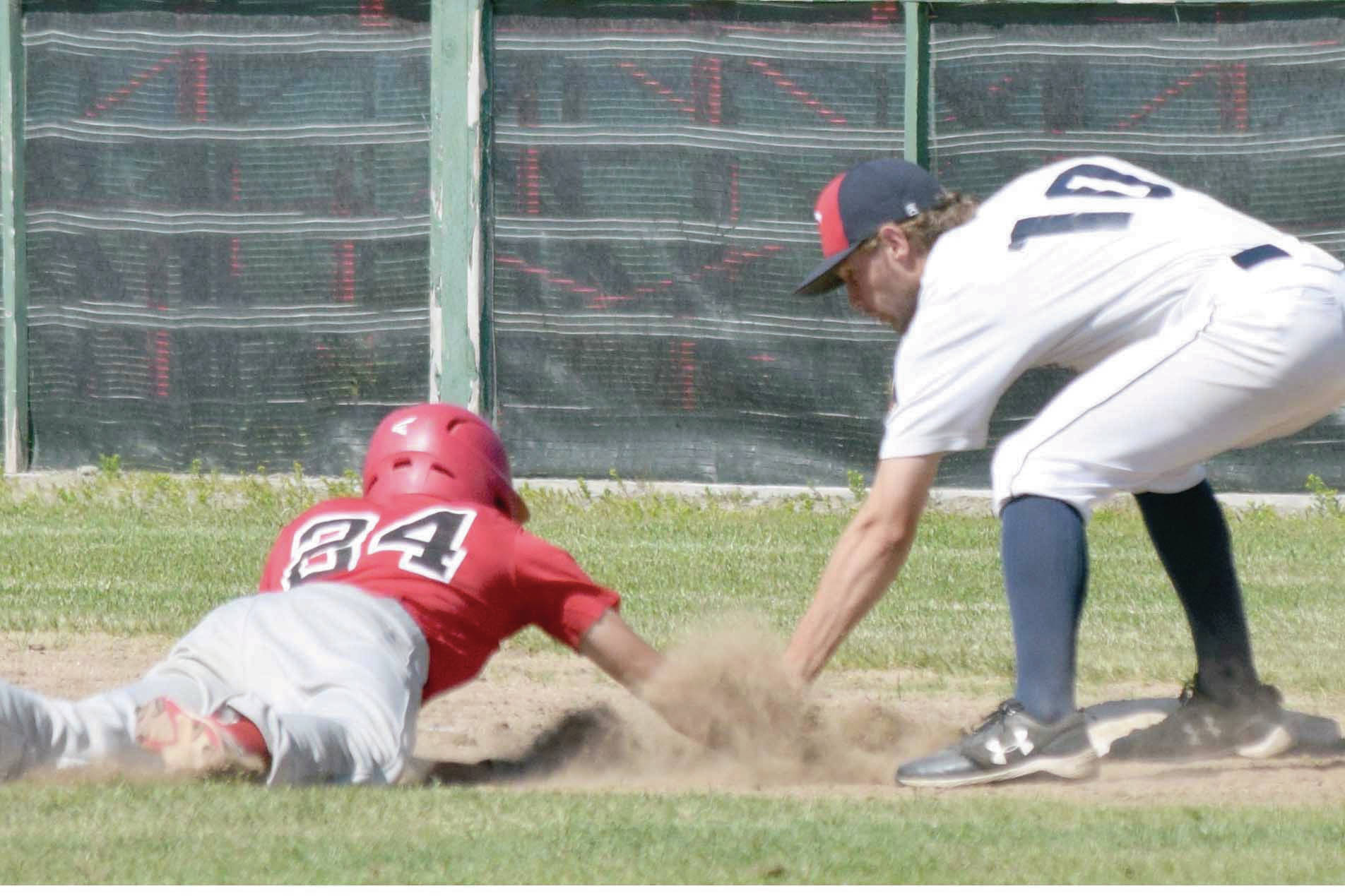 Post 20 first baseman Seth Adkins tags out Axel Shanks of Napoleon (Ohio) Post 300 on Wednesday, July 3, 2019, at Coral Seymour Memorial Park in Kenai, Alaska. Twins pitcher Mose Hayes picked off Shanks. (Photo by Jeff Helminiak/Peninsula Clarion)