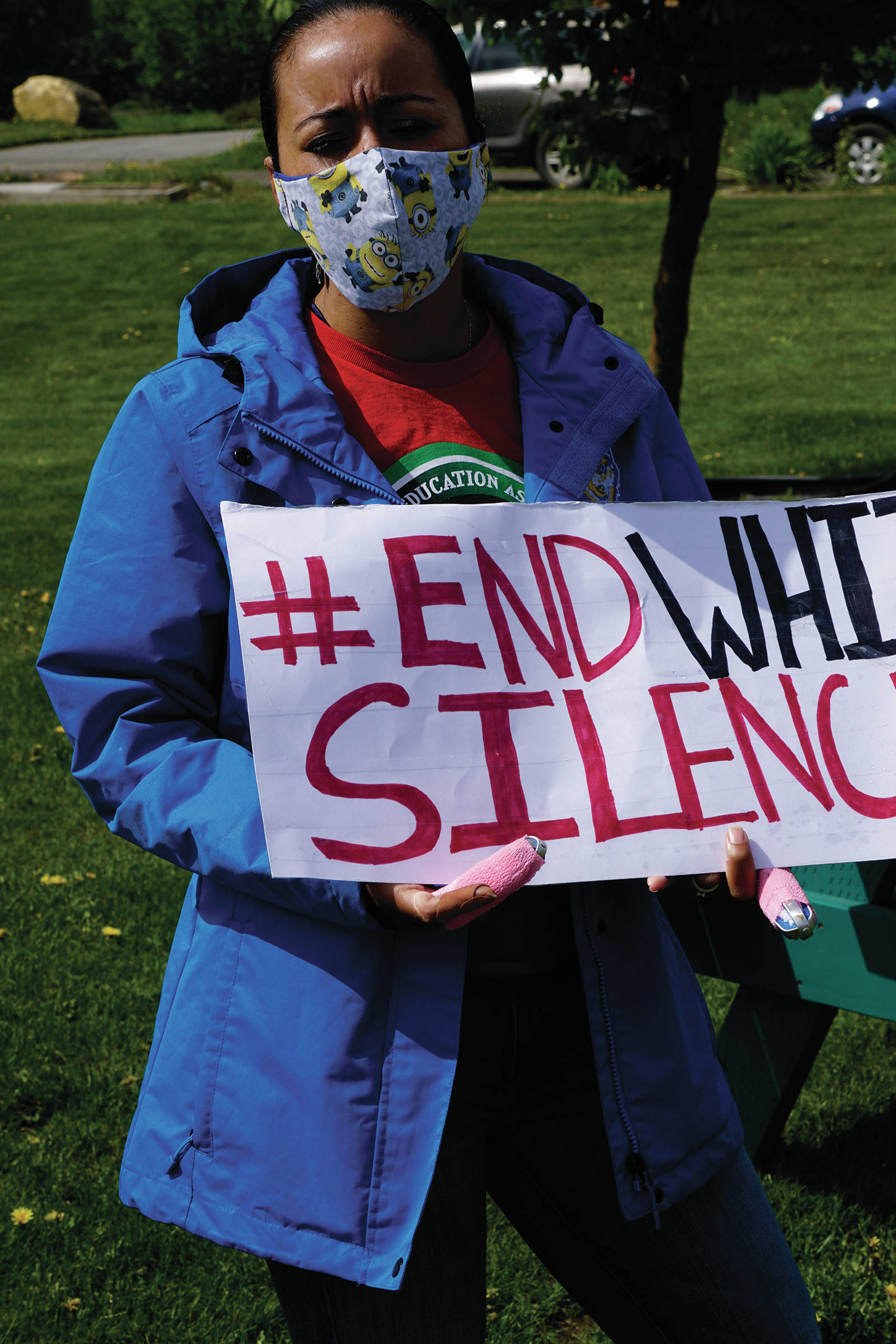 Winter Marshall-Allen holds a sign at a protest on Sunday, May 30, 2020, at WKFL Park in Homer, Alaska, in support of people of color who have been the subject of police violence, including George Floyd, a man who died May 25, 2020, in a police encounter in Minneapolis, Minnesota. (Photo by Michael Armstrong/Homer News)