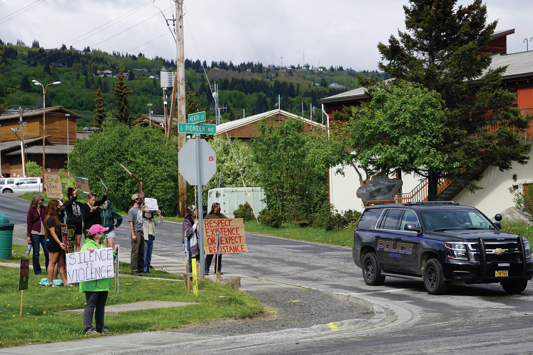 A Homer Police Department officer drives by a protest on Sunday, May 30, 2020, at WKFL Park in Homer, Alaska, in support of people of color who have been the subject of police violence, including George Floyd, a man who died May 25, 2020, in a police encounter in Minneapolis, Minnesota. Demonstrators at the Homer event also held signs that read “We (heart) our po po” — slang for police — and “Thank you, HPD.” (Photo by Michael Armstrong/Homer News)