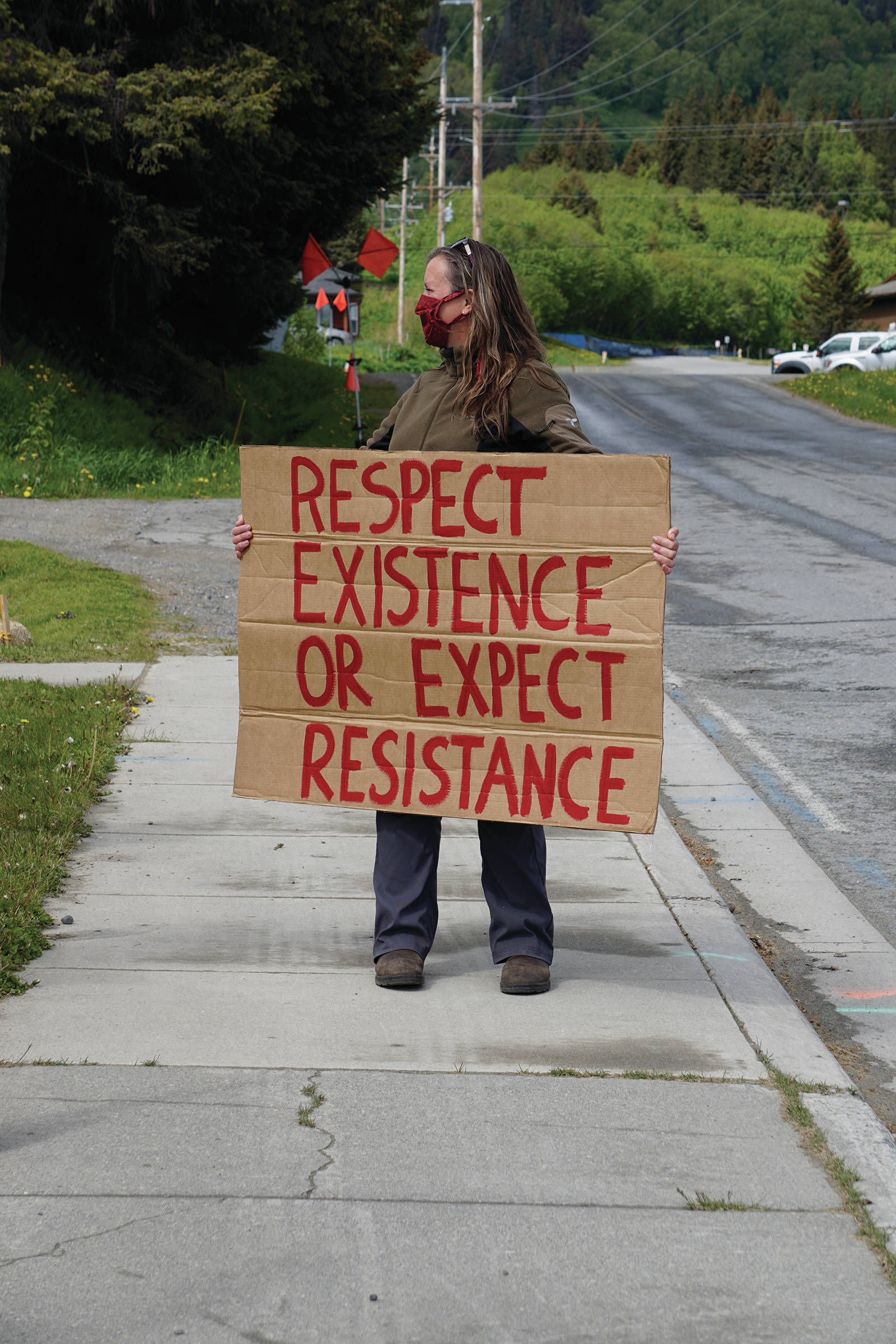 Jenni Stowe holds a sign at a protest on Sunday, May 30, 2020, at WKFL Park in Homer, Alaska, in support of people of color who have been the subject of police violence, including George Floyd, a man who died May 25, 2020, in a police encounter in Minneapolis, Minnesota. (Photo by Michael Armstrong/Homer News)