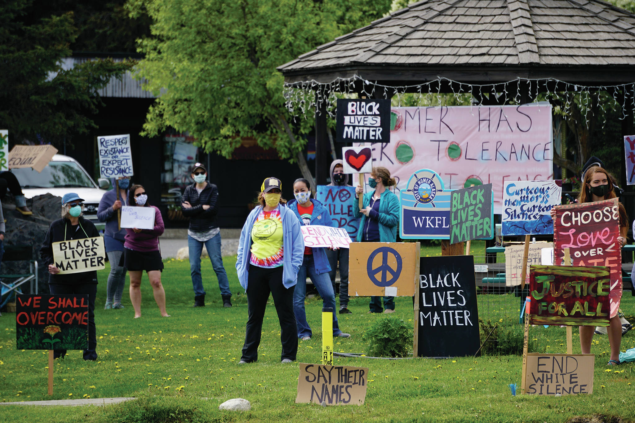 People hold signs at a protest on Sunday, May 30, 2020, at WKFL Park in Homer, Alaska, in support of people of color who have been the subject of police violence, including George Floyd, a man who died May 25, 2020, in a police encounter in Minneapolis, Minnesota. (Photo by Michael Armstrong/Homer News)