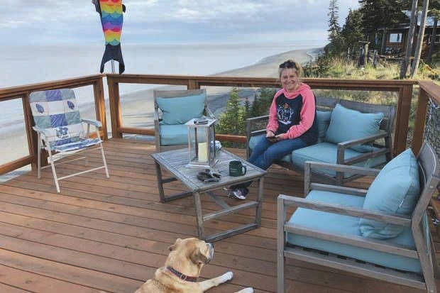 Photo provided by Ocean Bluff B&B                                Tammy Kehrer of Palmer sits on the deck overlooking Cook Inlet at Ocean Bluff B&B in Kasilof. Kehrer is the daughter of owner Kathy Carlisle.