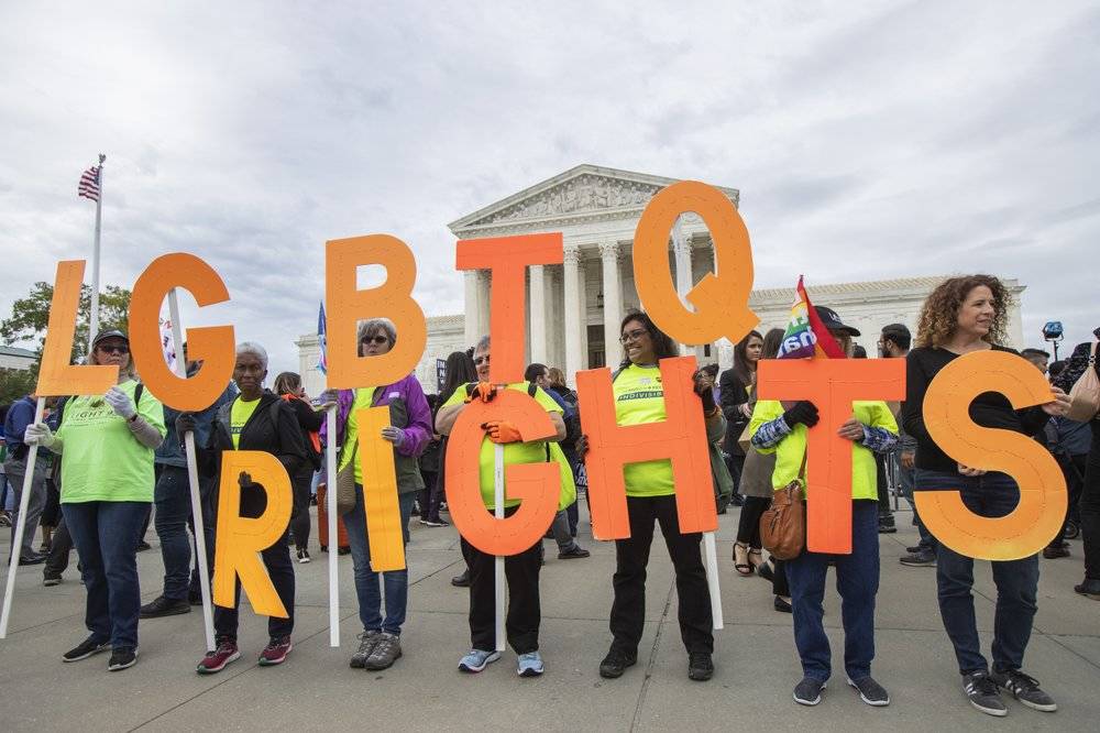 Manuel Balce Ceneta / associated press file                                 Supporters of LGBTQ+ rights hold placards in front of the U.S. Supreme Court in Washington on Oct. 8, 2019.