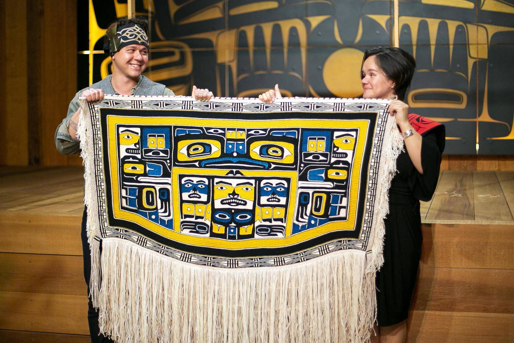 Lily Hope and Ricky Tagaban display the robe they collaborated to weave at its First Dance ceremony at the Sealaska Heritage Institute on Monday, June 22, 2020. (Courtesy photo | Annie Bartholomew)