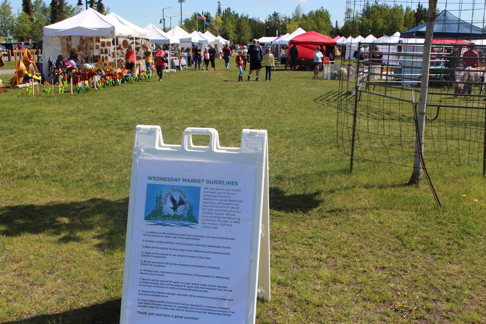 A sign detailing modified health protocols for the Wednesday Market is seen here at Soldotna Creek Park in Soldotna, Alaska on June 10, 2020. (Photo by Brian Mazurek/Peninsula Clarion)