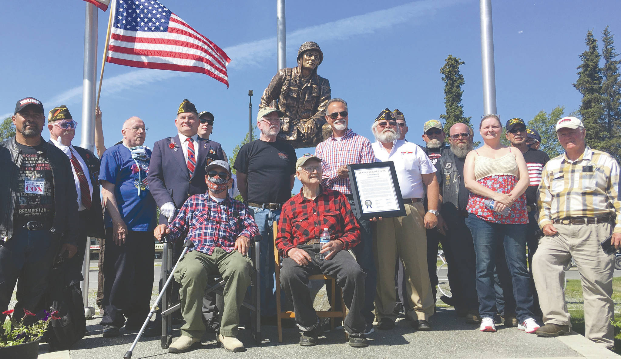 Jeff Helminiak/Peninsula Clarion                                A group of veterans and local dignitaries stand in front of the newly unveiled Iron Mike statue at Soldotna Creek Park on Saturday.