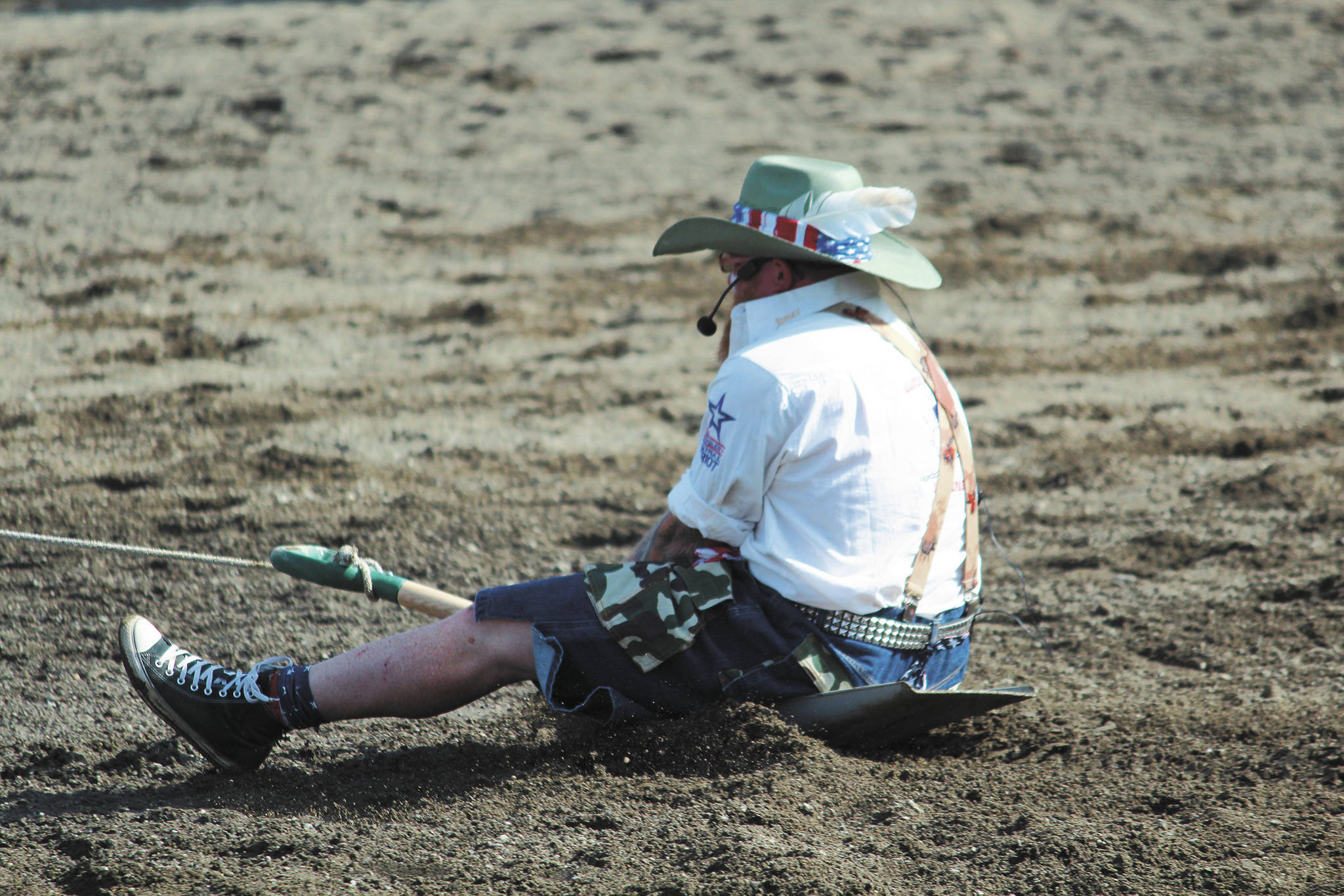 Rodeo announcer James Hastings is pulled behind a horse during the shovel race at the annual Ninilchik Rodeo on Saturday, July 4, 2020 at the Kenai Peninsula Fairgrounds in Ninilchik, Alaska.