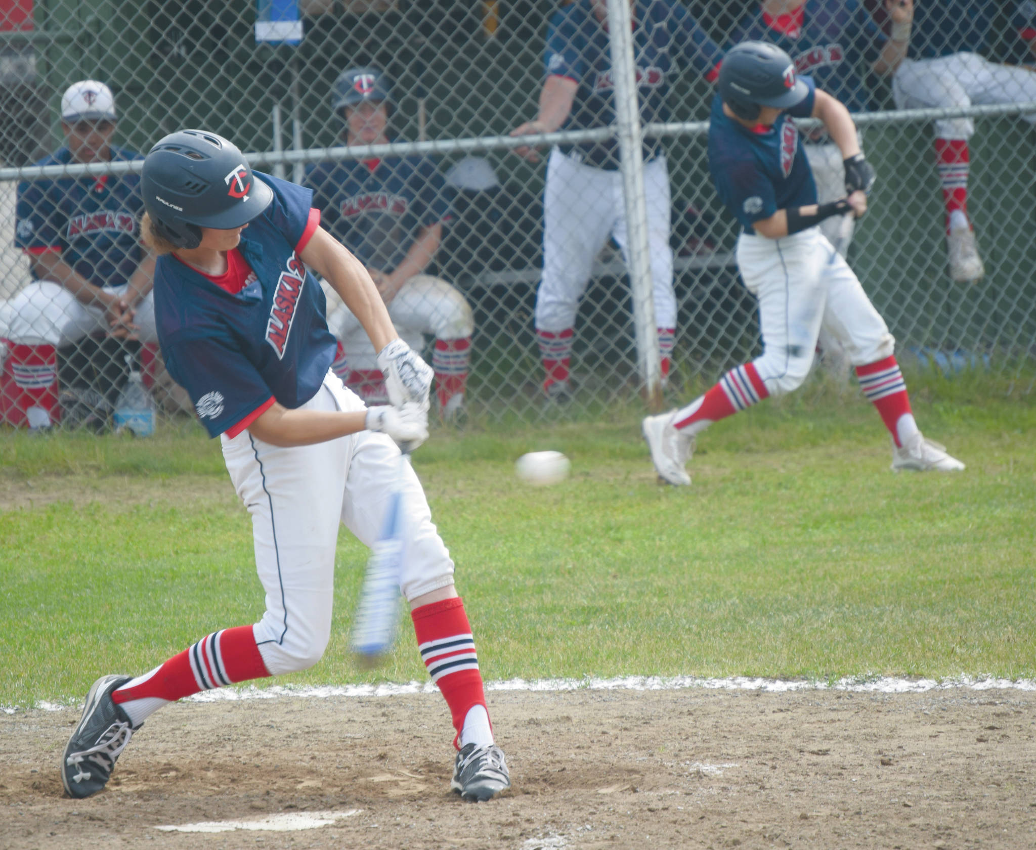 Alaska 20’s Davey Belger fouls off a pitch against Eagle River while Harrison Metz times up the pitcher in the on-deck circle Tuesday, July 7, 2020, at the Kenai Little League fields in Kenai, Alaska. (Photo by Jeff Helminiak/Peninsula Clarion)