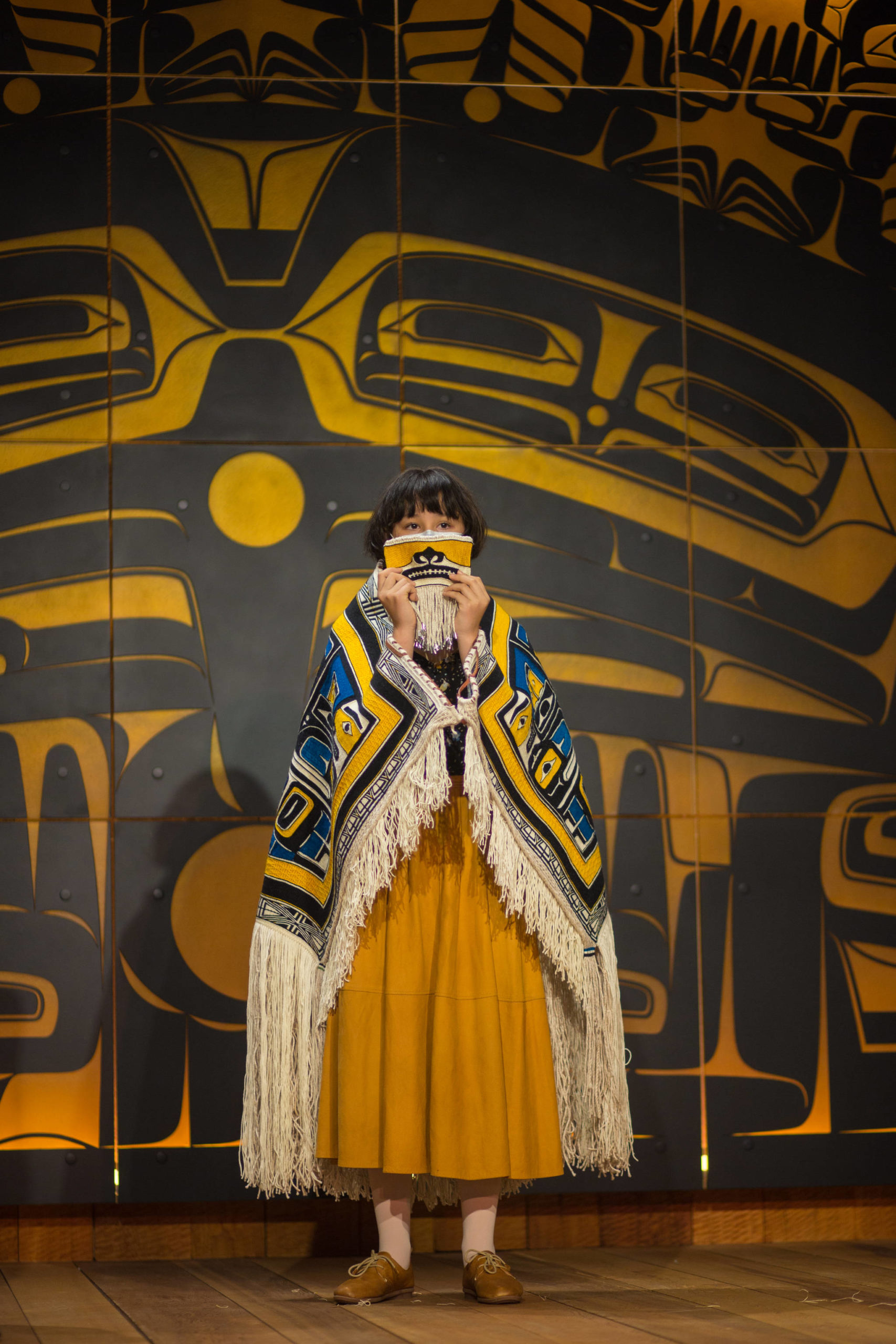 Elizabeth Hope holds up the Chilkat Protector Mask at a ceremony. (Courtesy Photo | Sydney Akagi Photography for Lily Hope)