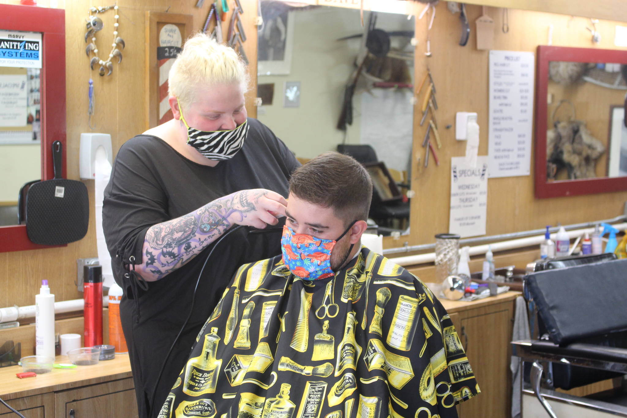 Skylar Giordano cuts Ryan Huerta’s hair at RD’s Barber Shop in Kenai, Alaska on Thursday, July 9, 2020. RD’s is one of the 186 local businesses and nonprofits in Kenai that already received financial assistance through the City of Kenai’s Grant Program. (Photo by Brian Mazurek/Peninsula Clarion)