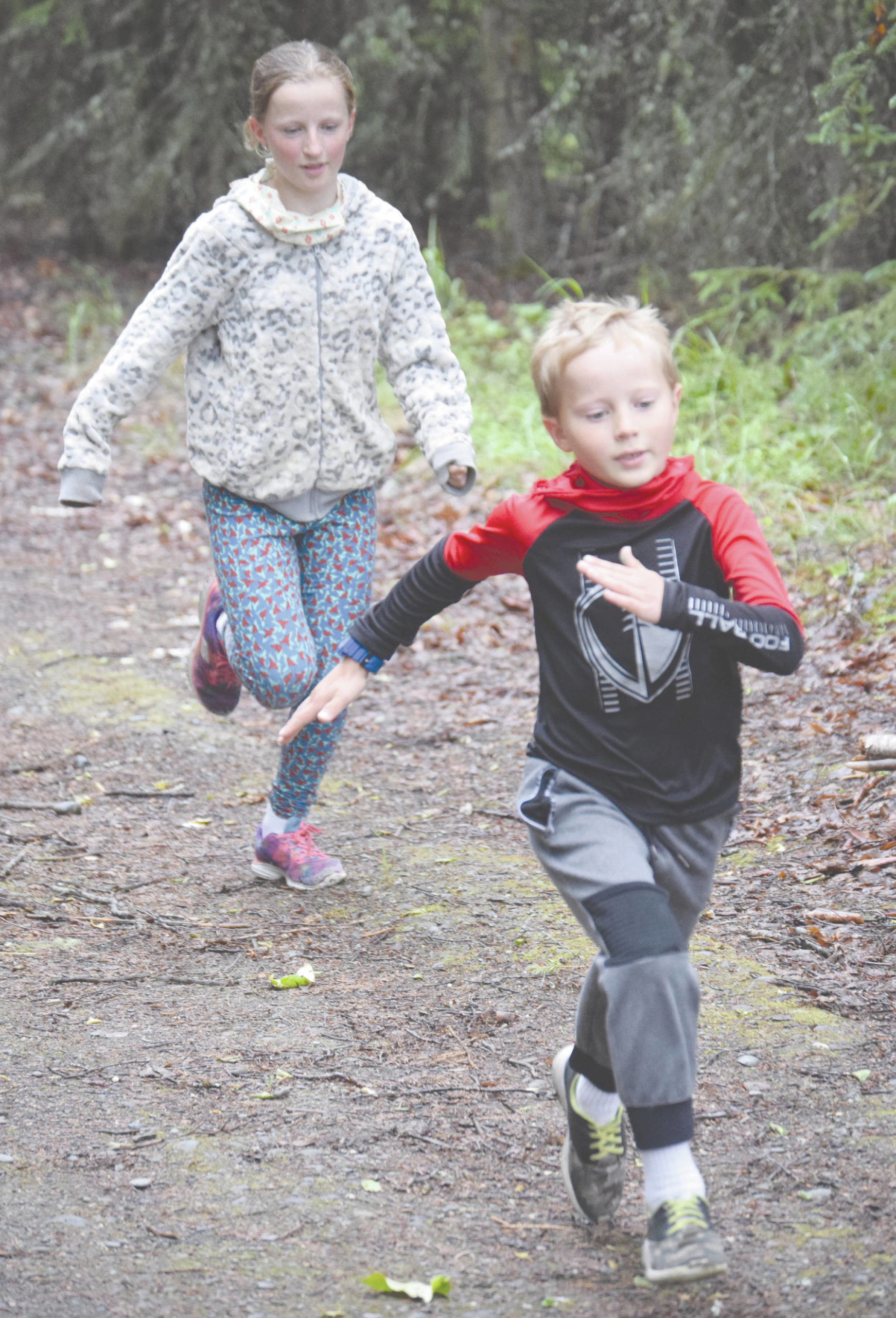 Dillon, 7, and Valarie, 11, McAnelly compete in the 1-kilometer kids race at the Salmon Run Series in Soldotna, Alaska, on Wednesday, July 8, 2020. Dillon won the race, while Valarie was second. (Photo by Jeff Helminiak/Peninsula Clarion)