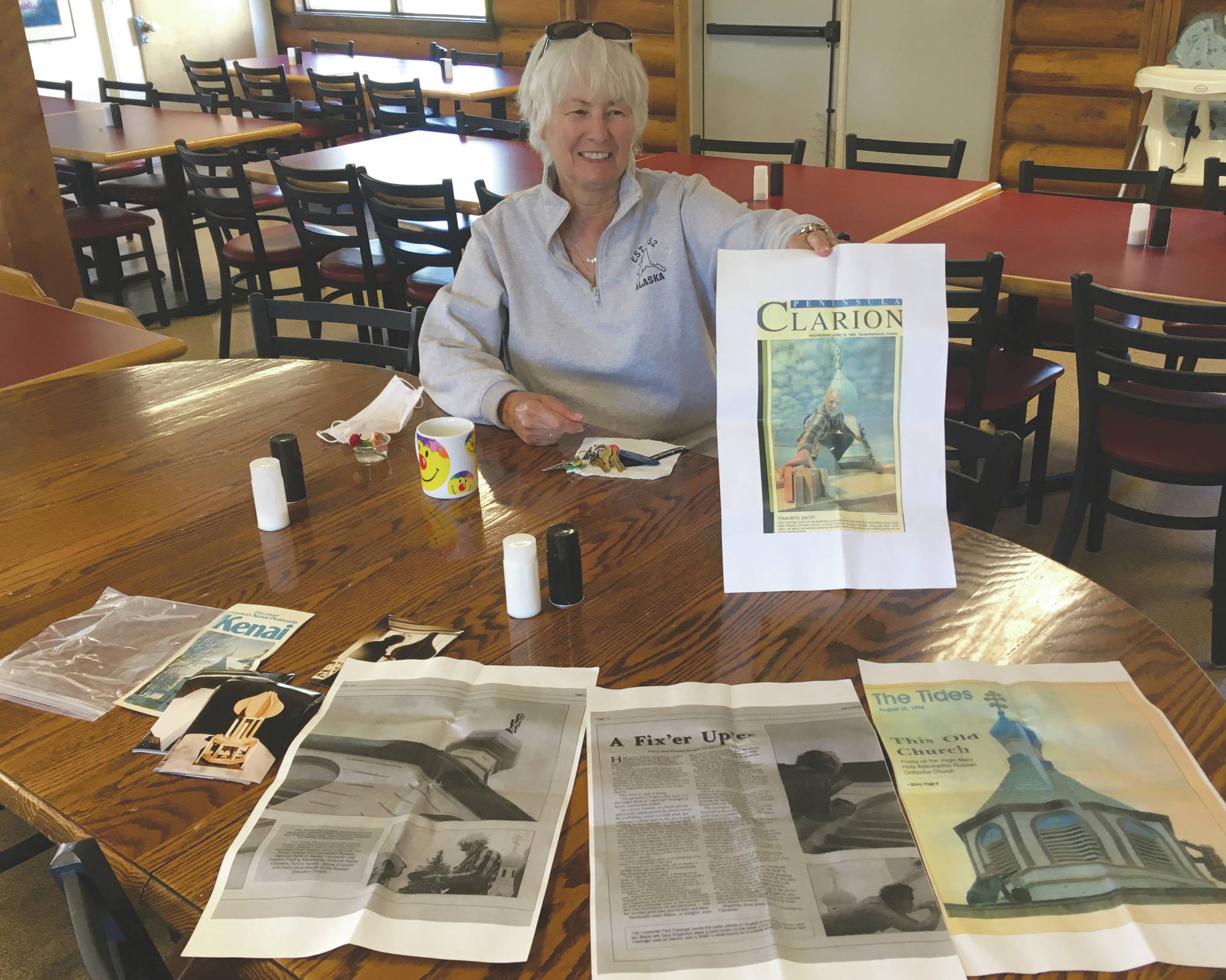 Jeff Helminiak/Peninsula Clarion                                Dorothy Gray displays the contents of a time capsule found Monday, on the first day of the improvement project in Kenai on Monday.