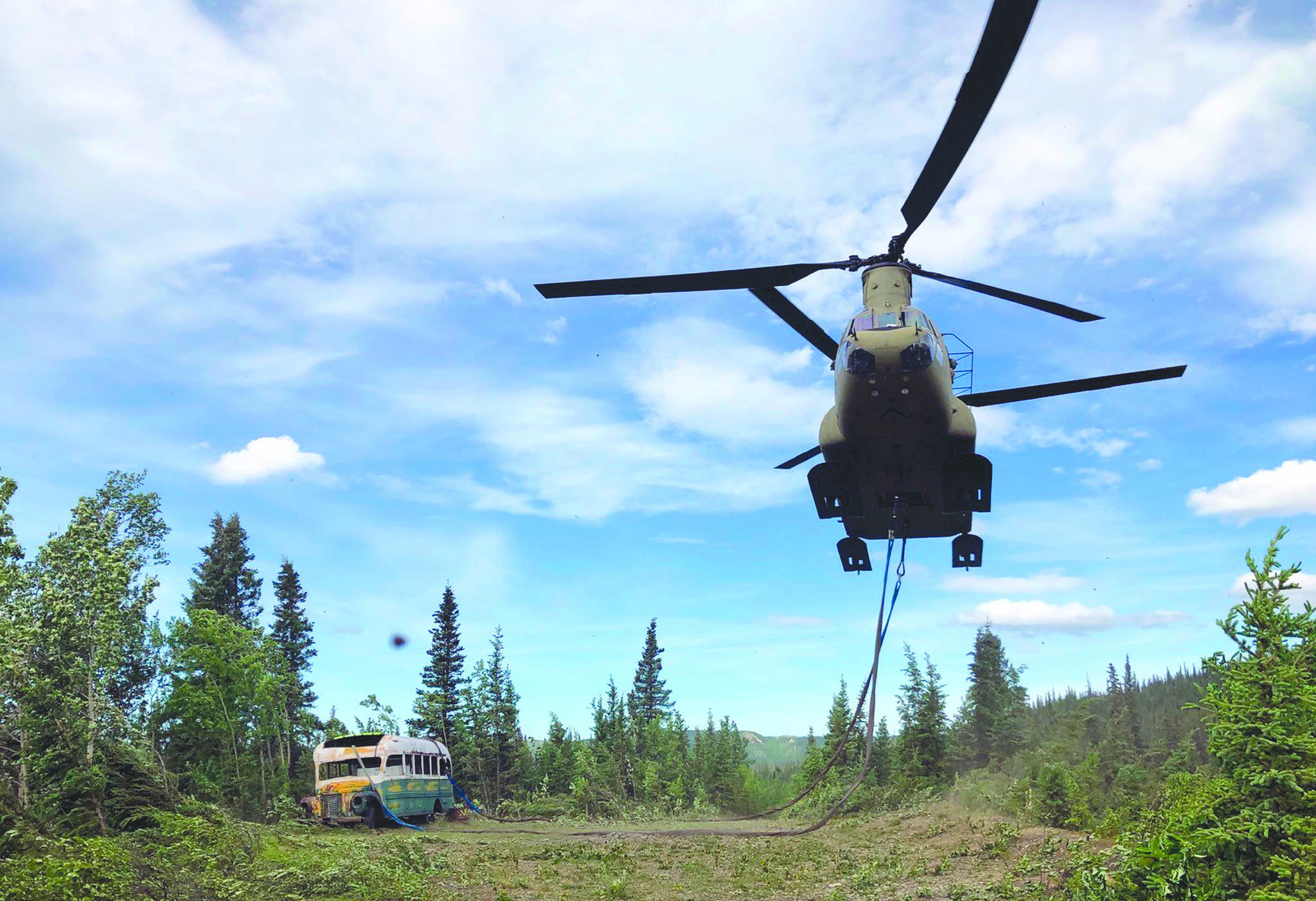 In this photo released by the Alaska National Guard, Alaska Army National Guard soldiers use a CH-47 Chinook helicopter to removed an abandoned bus, popularized by the book and movie “Into the Wild,” out of its location in the Alaska backcountry Thursday, June 18, 2020, as part of a training mission. Alaska Natural Resources Commissioner Corri Feige, in a release, said the bus will be kept in a secure location while her department weighs various options for what to do with it. (Sgt. Seth LaCount/Alaska National Guard via AP)