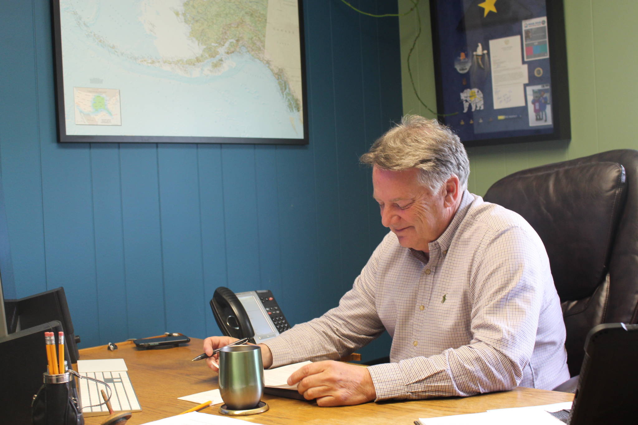 Tim Dillon, executive director of the Kenai Peninsula Economic Development District, is seen here reviewing his proposed changes to the Alaska Legislature regarding the AK CARES funds for small businesses at the KPEDD office in Kenai, Alaska, on July 1, 2020. (Photo by Brian Mazurek/Peninsula Clarion)