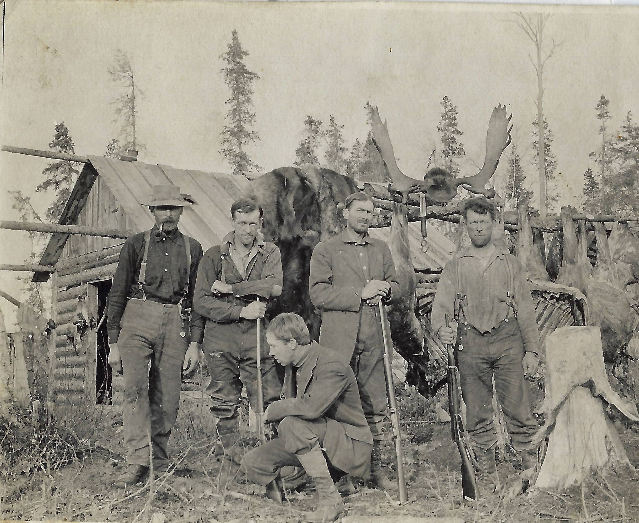 Ed Haun (kneeling) poses with a group of other hunters and several hanging quarters of moose meat, circa late 1910s. The structure may be the “Hauns cabin” near the Chickaloon River, referred to in a 1914 ranger’s diary. (Courtesy of the Hope and Sunrise Historical Society)