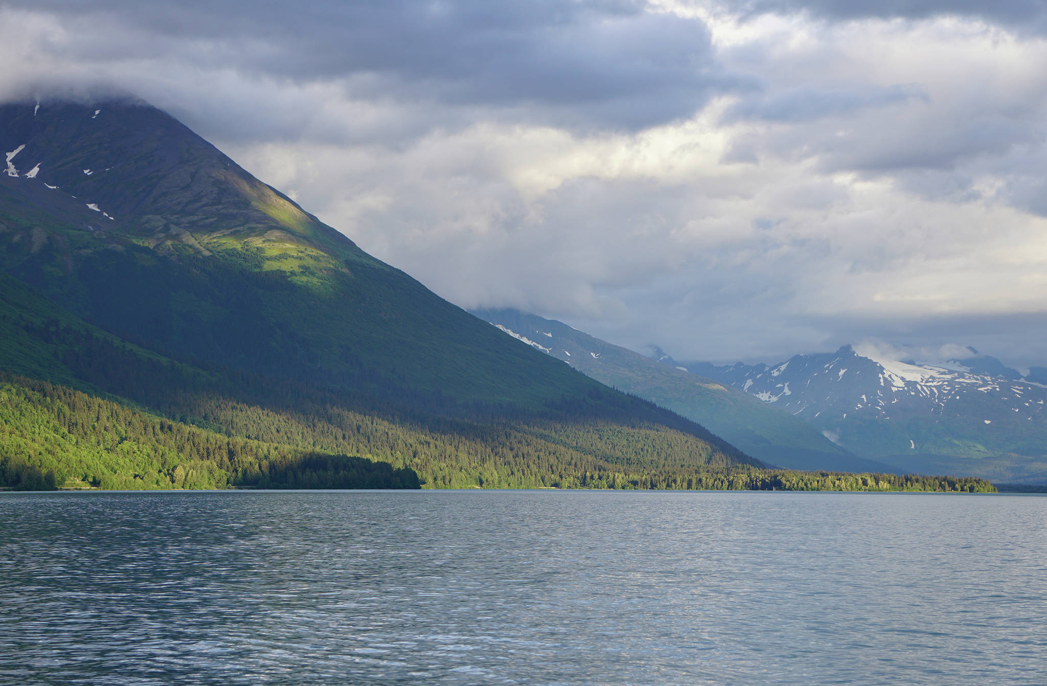 Sun dapples the mountains near the U.S. Forest Service Trail River Campground on July 22, 2020, near Moose Pass, Alaska. (Photo by Michael Armstrong/Homer News)