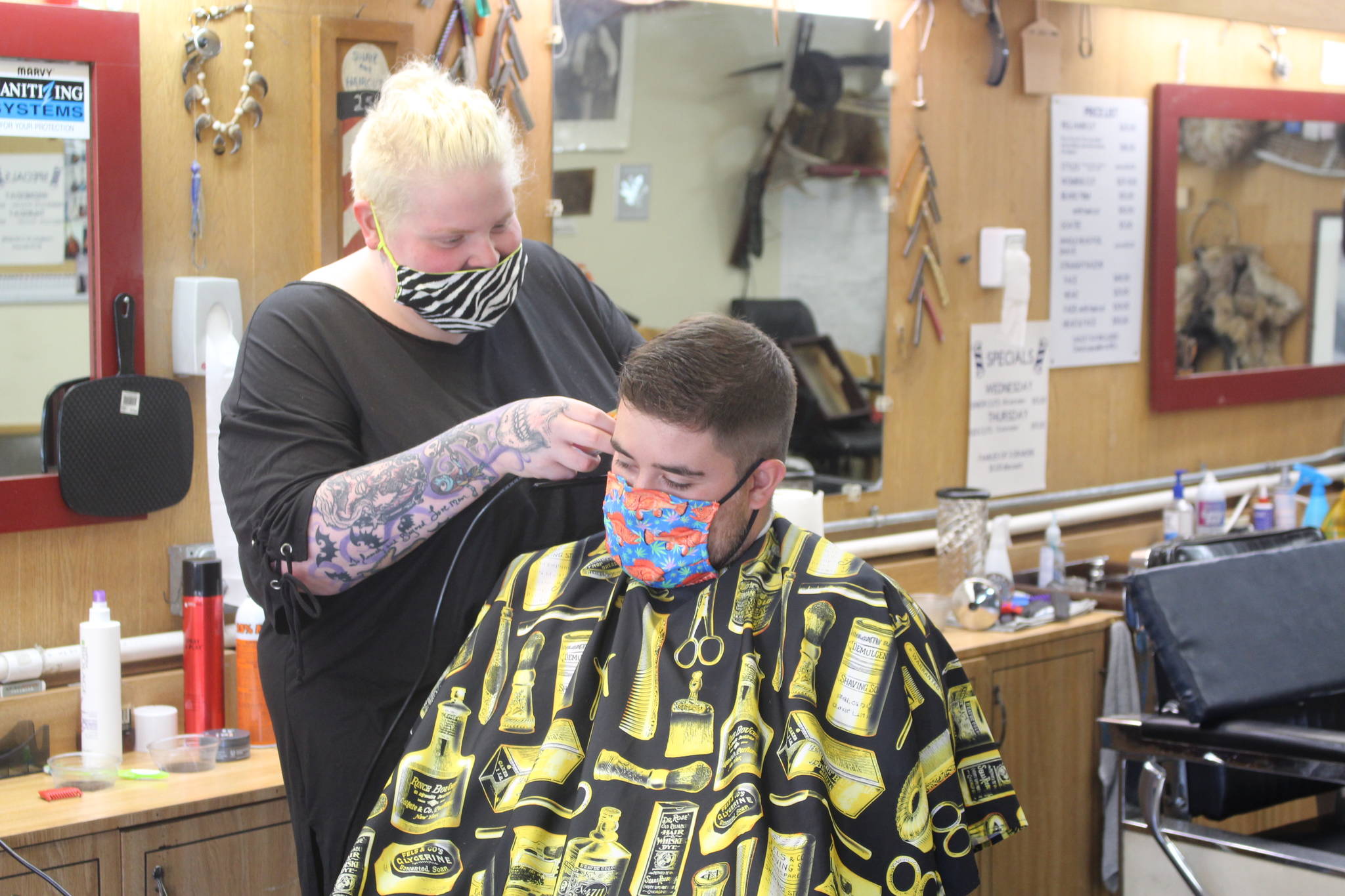 Skylar Giordano cuts Ryan Huerta’s hair at RD’s Barber Shop in Kenai on July 9, 2020. (Photo by Brian Mazurek/Peninsula Clarion)