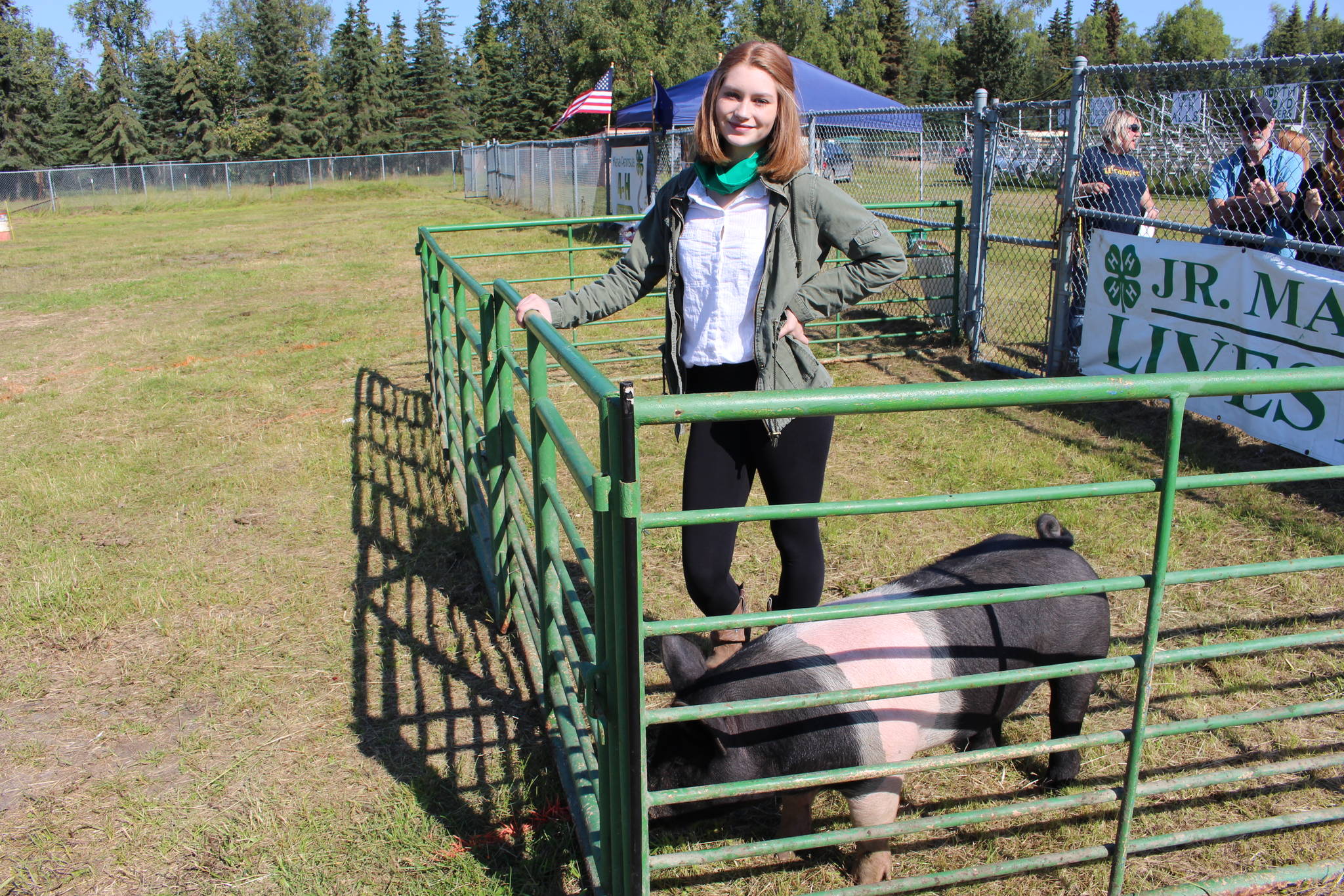 Destiny Martin and her pig, Outlaw, are seen here at the 4-H Junior Market Drive-in Auction at the Soldotna Rodeo Grounds on Aug. 15, 2020. (Photo by Brian Mazurek/Peninsula Clarion)