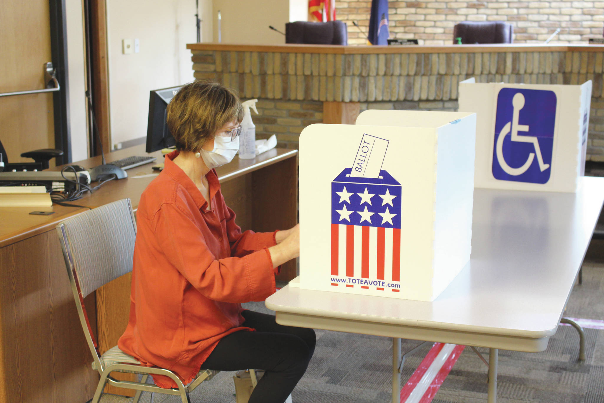 Brian Mazurek / Peninsula Clarion                                Kim Lofstedt casts her vote early in Alaska’s Primary Election at Kenai City Hall on Monday.