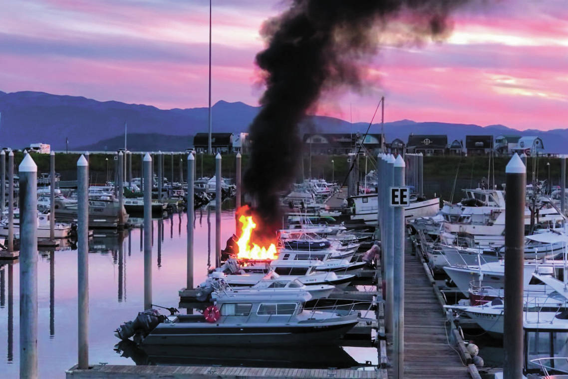 Photo by John Pratt                                Flames and smoke rise from a 32-foot fiberglass boat docked in the Homer Harbor on the evening of Friday in Homer. No one was harmed and the Homer Volunteer Fire Department put out the fire.