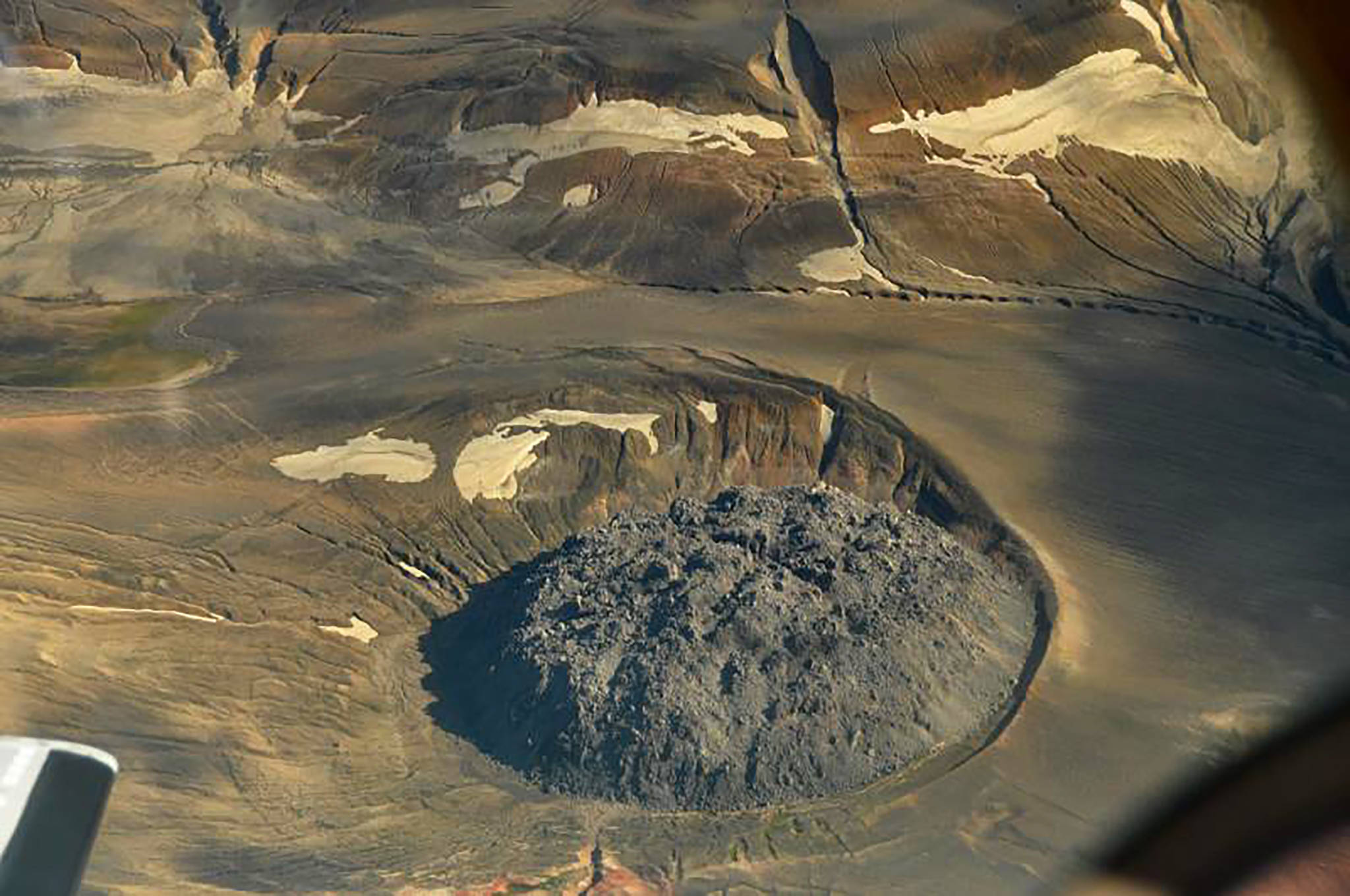 This Aug. 20, 2010 photo provided by the U.S. Geological Survey shows the lava dome named Novarupta marks the 1.2 mile (2 km) wide vent of the 1912 Novarupta-Katmai eruption. While western U.S. states were suffering from hazy red skies from wildfires, Alaska was dealing with an air quality problem born a century ago. Strong southerly winds picked up loose ash from a 1912 volcanic eruption, sending an ash cloud about 4,000 feet into the sky. (Peter Kelly/U.S. Geological Survey via AP)