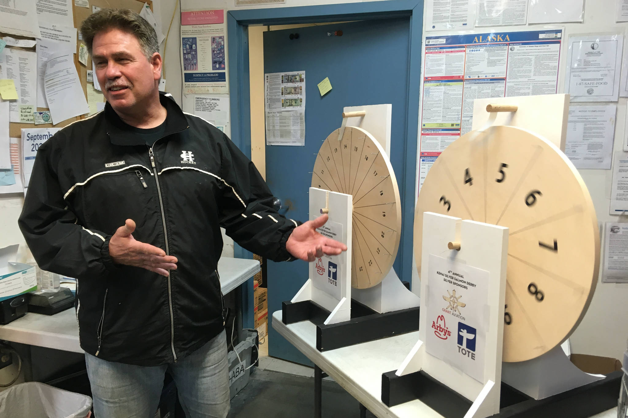 Kenai Mayor Brian Gabriel spins a wheel to determine the Magic Weight at the Fourth Annual Kenai Silver Salmon Derby on Tuesday, Sept. 15, 2020, at Three Bears grocery store in Kenai, Alaska. (Photo by Jeff Helminiak/Peninsula Clarion)