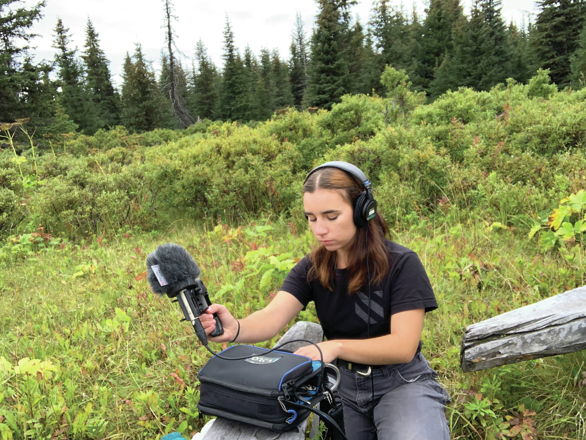Lindsey Schneider records nature sounds for her radio play, “Knife Skills,” in August 2020 in Homer, Alaska. (Photo courtesy of Lindsey Schneider)