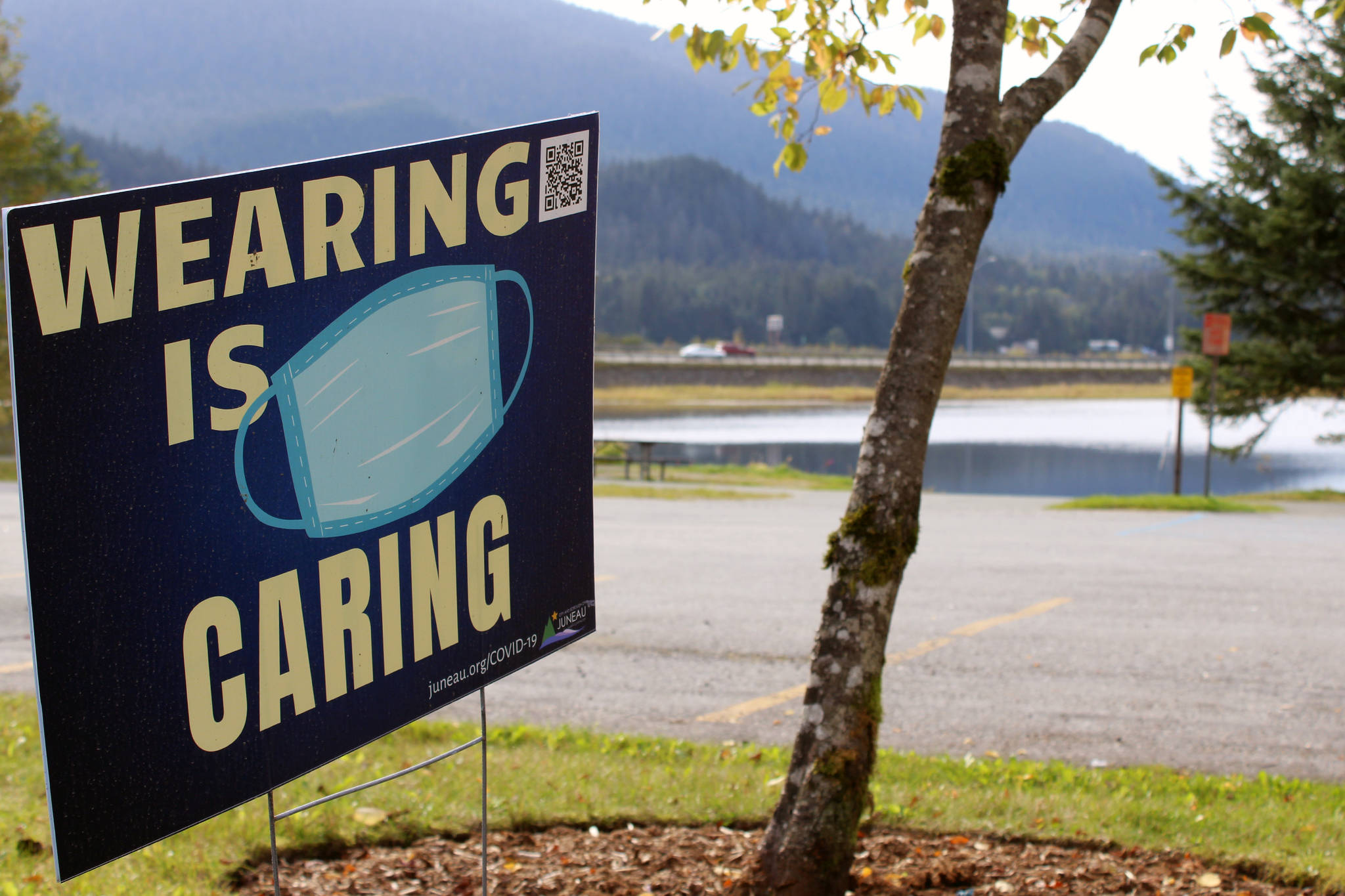 A sign seen near Twin Lakes on Sept. 17 encourages residents to wear cloth face coverings while in public. A social gathering tied to a recent cluster of cases of COVID-19 is unlikely to lead to punishment, but city officials are hopeful it may encourage people to be more cautious. (Ben Hohenstatt / Juneau Empire)
