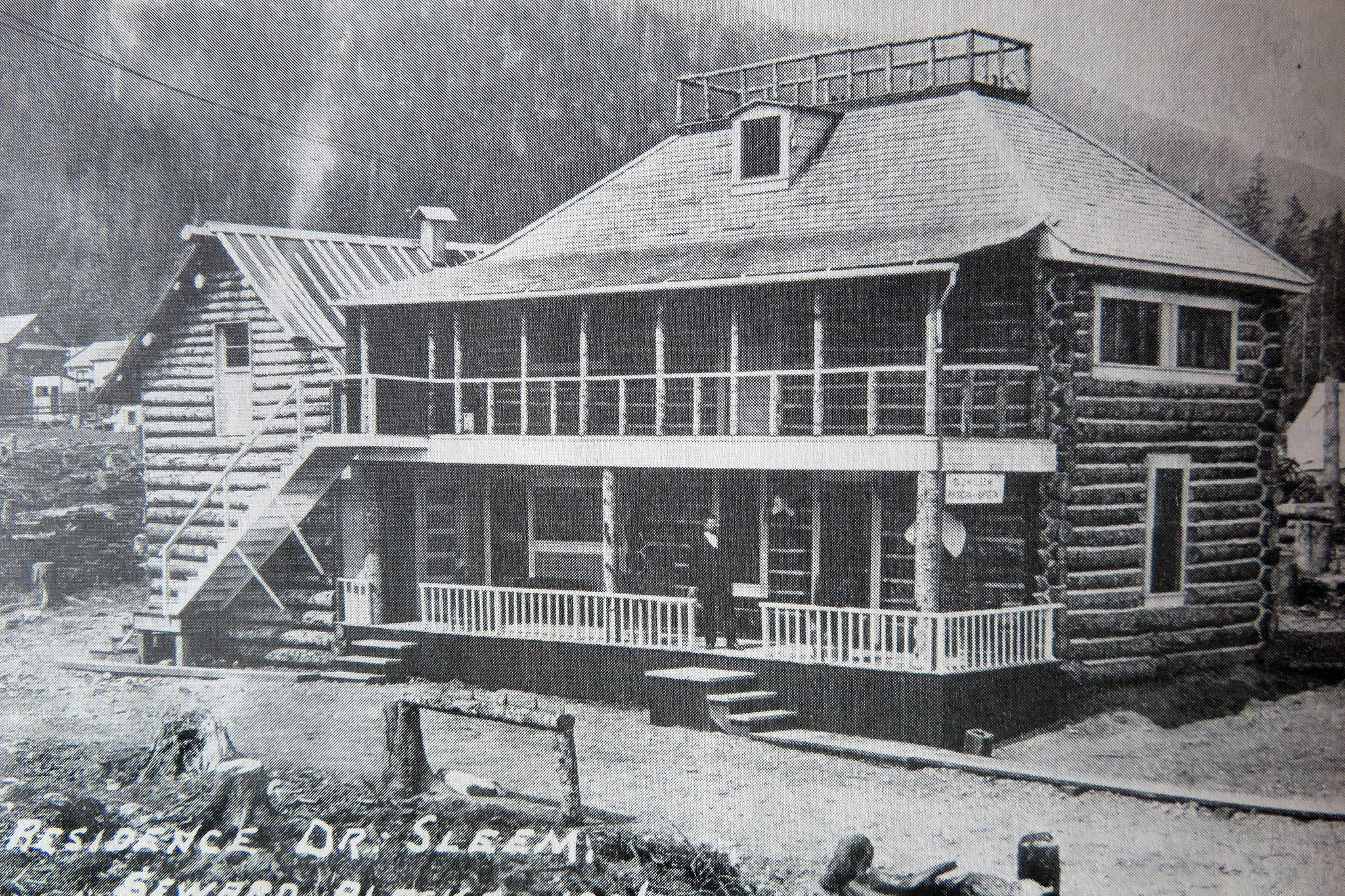 Photo from the Anchorage Museum of History and Art 
Dr. David Hassan Sleem stands on the front porch of his large Seward home in 1906.