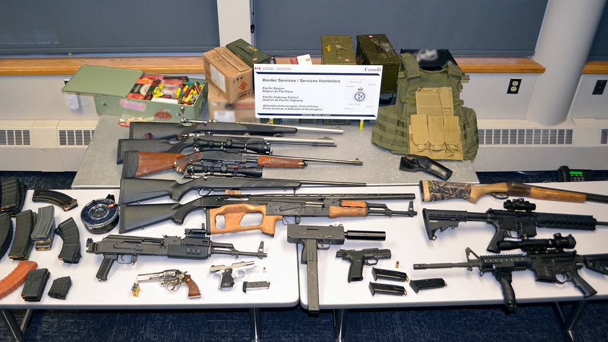 An Alaska man will appear in Canadian court on Sept. 21 after an incident entering Canada when border security officers seized the fourteen firearms pictured, alongside loaded magazines, ammunition, and other paraphernalia at a crossing southeast of Vancouver. (Courtesy photo / Canada Border Services Agency)