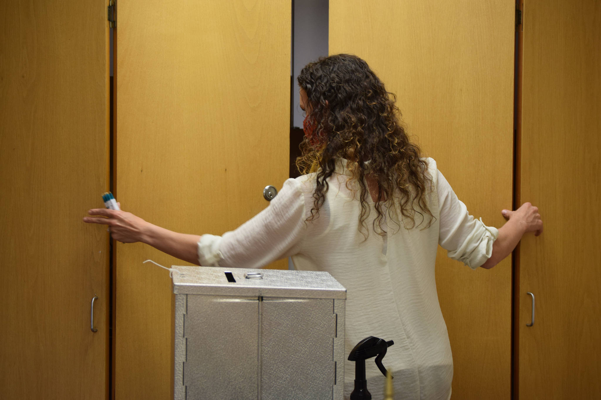 Kenai Deputy City Clerk Jacquelyn LaPlante adjusts cabinets behind a ballot box at the Kenai City Clerk’s office on Monday, Sept. 21, in Kenai, Alaska. (Ashlyn O’Hara / Peninsula Clarion)