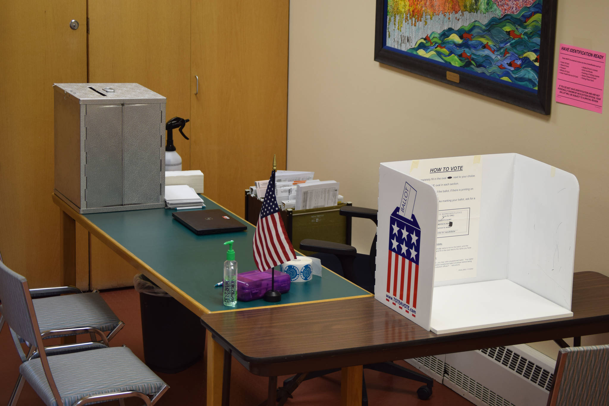 A tabletop voting booth is seen next to a ballot box at the Kenai city clerk’s office on Monday in Kenai